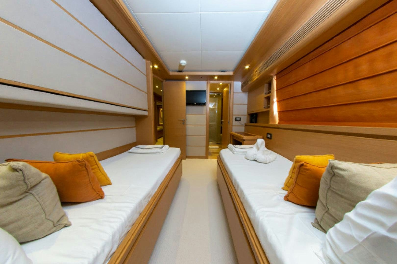 a room with a bed and a television aboard ADAR Yacht for Sale
