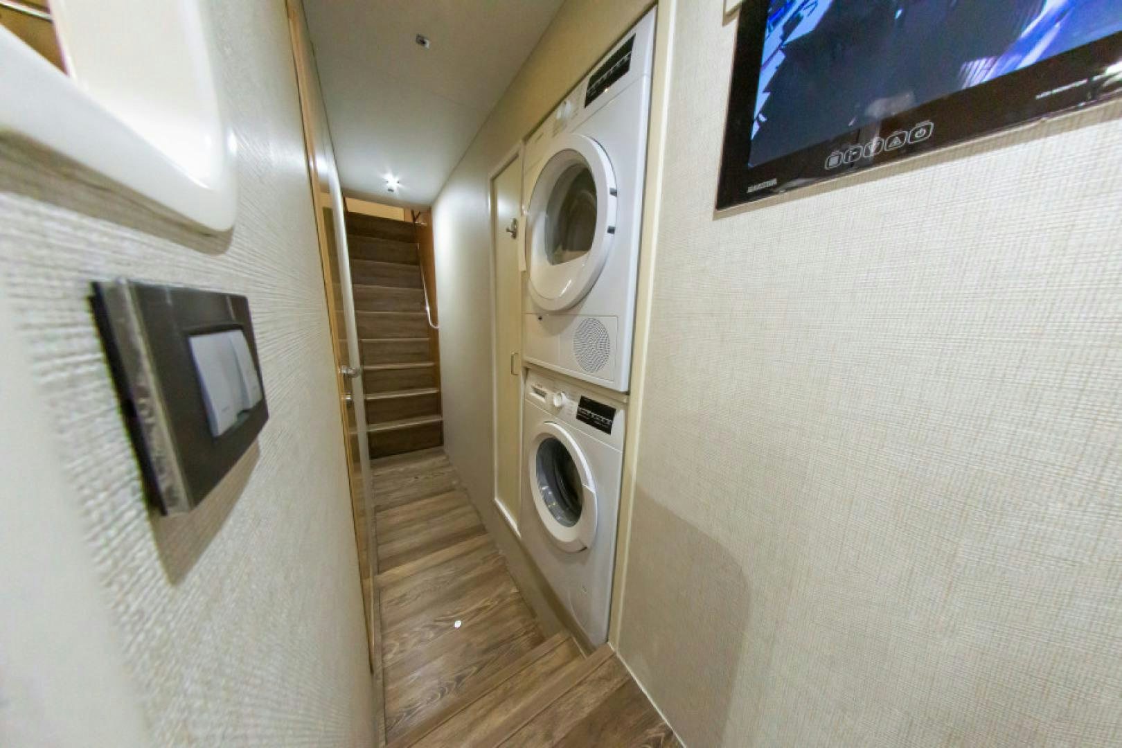 a room with a washer and dryer aboard ADAR Yacht for Sale