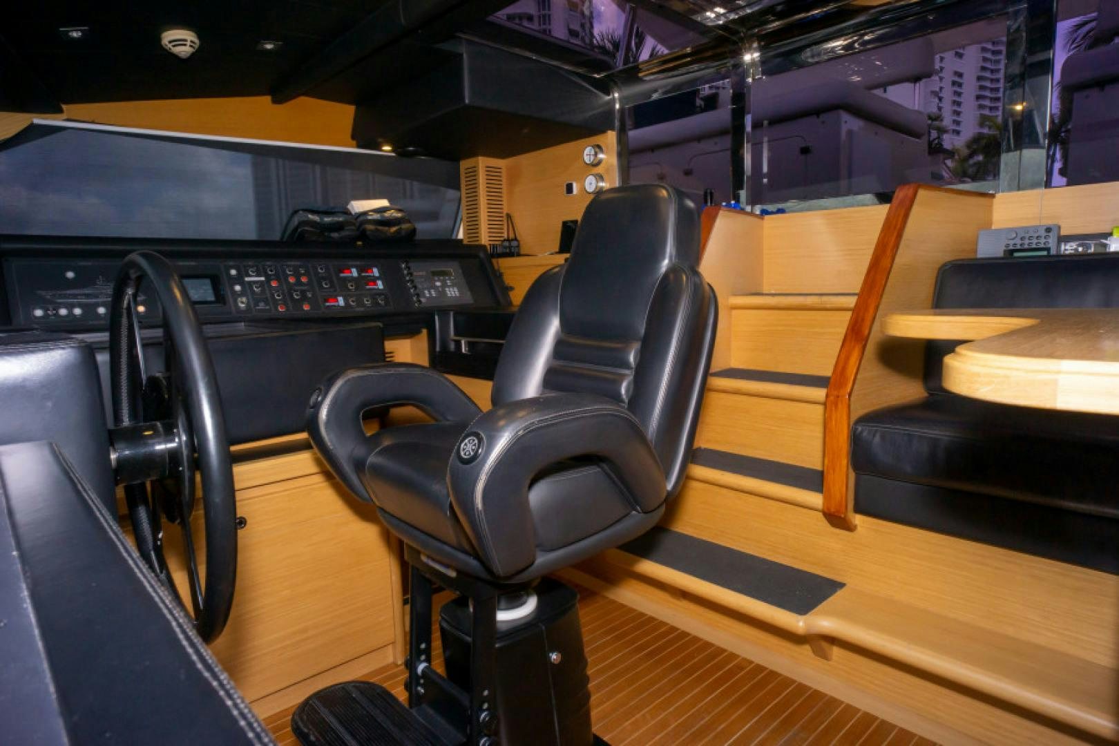 a black office chair in front of a piano aboard ADAR Yacht for Sale