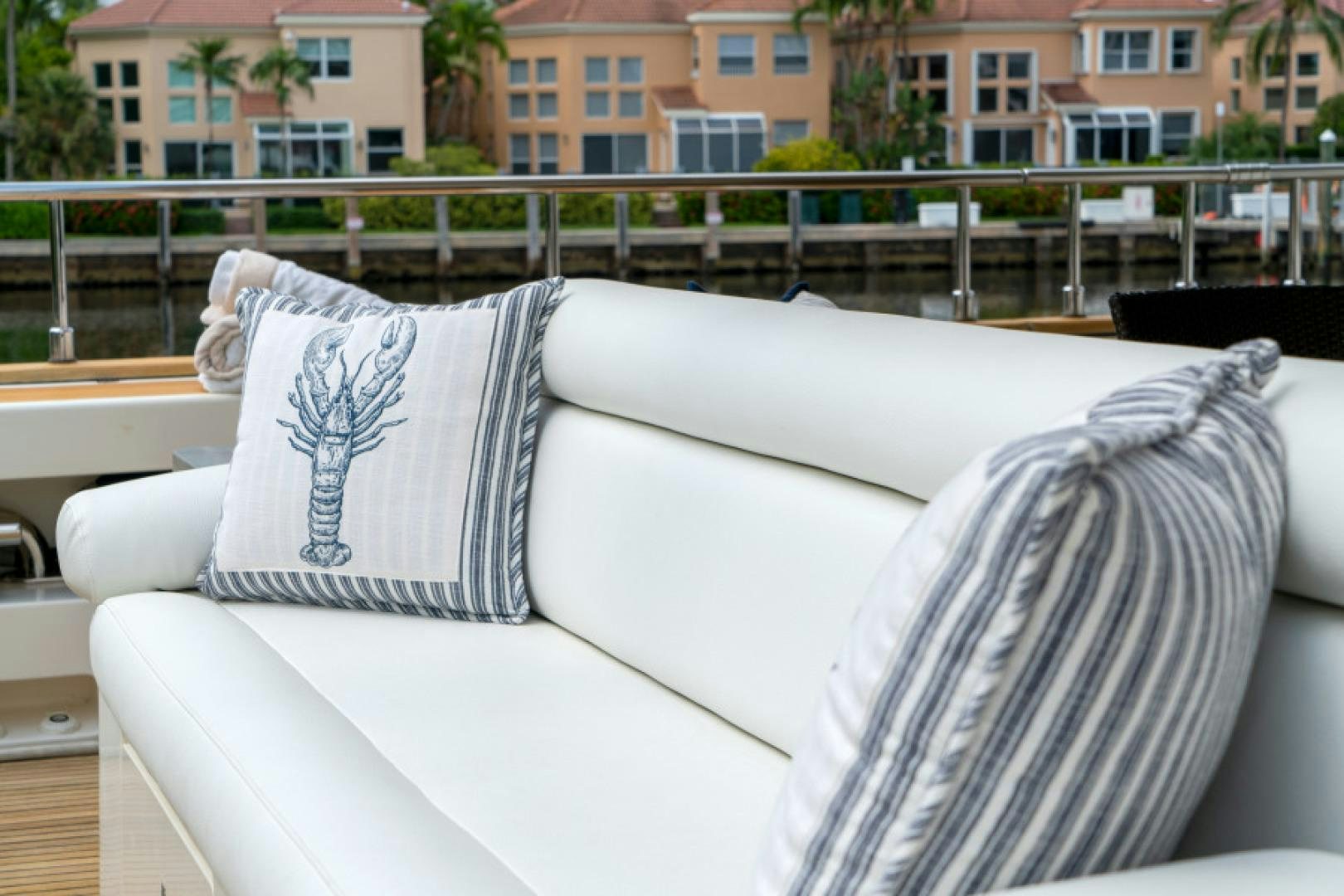 a couch with pillows on it aboard ADAR Yacht for Sale