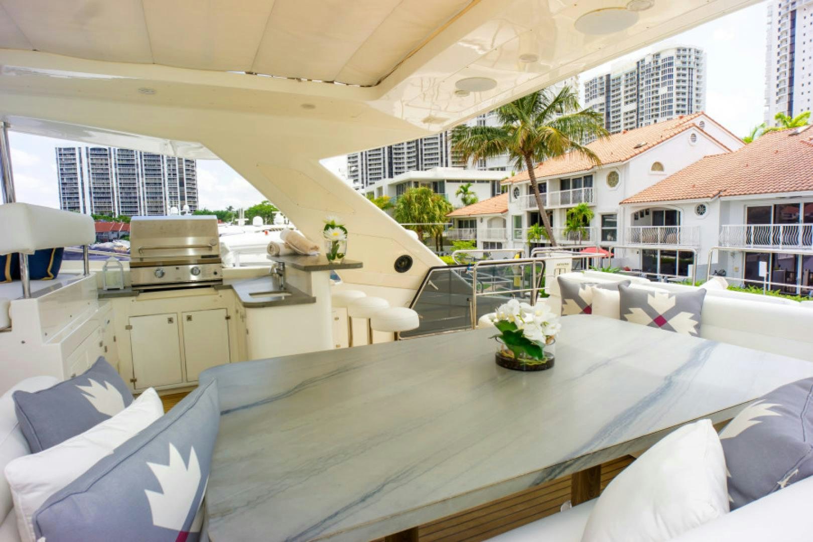a large white room with a table and chairs and a plant on the table aboard ADAR Yacht for Sale