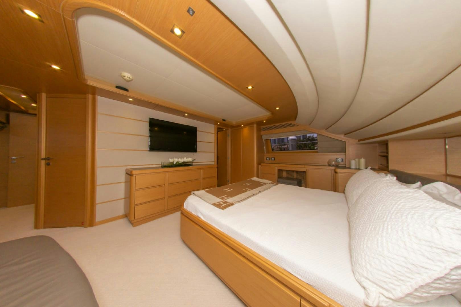 a room with a bed and a tv aboard ADAR Yacht for Sale