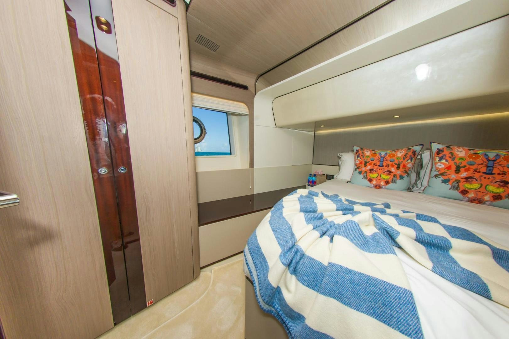 a room with a bed and a closet aboard RINA Yacht for Sale