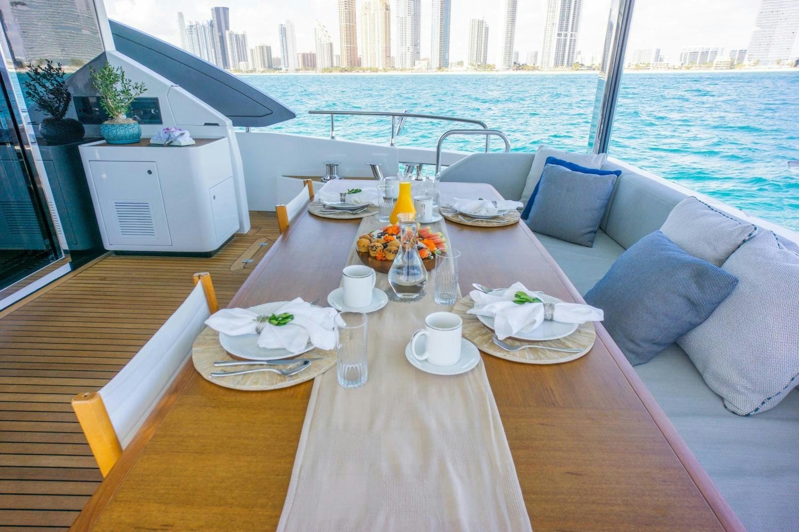 a table with plates and cups on it aboard RINA Yacht for Sale