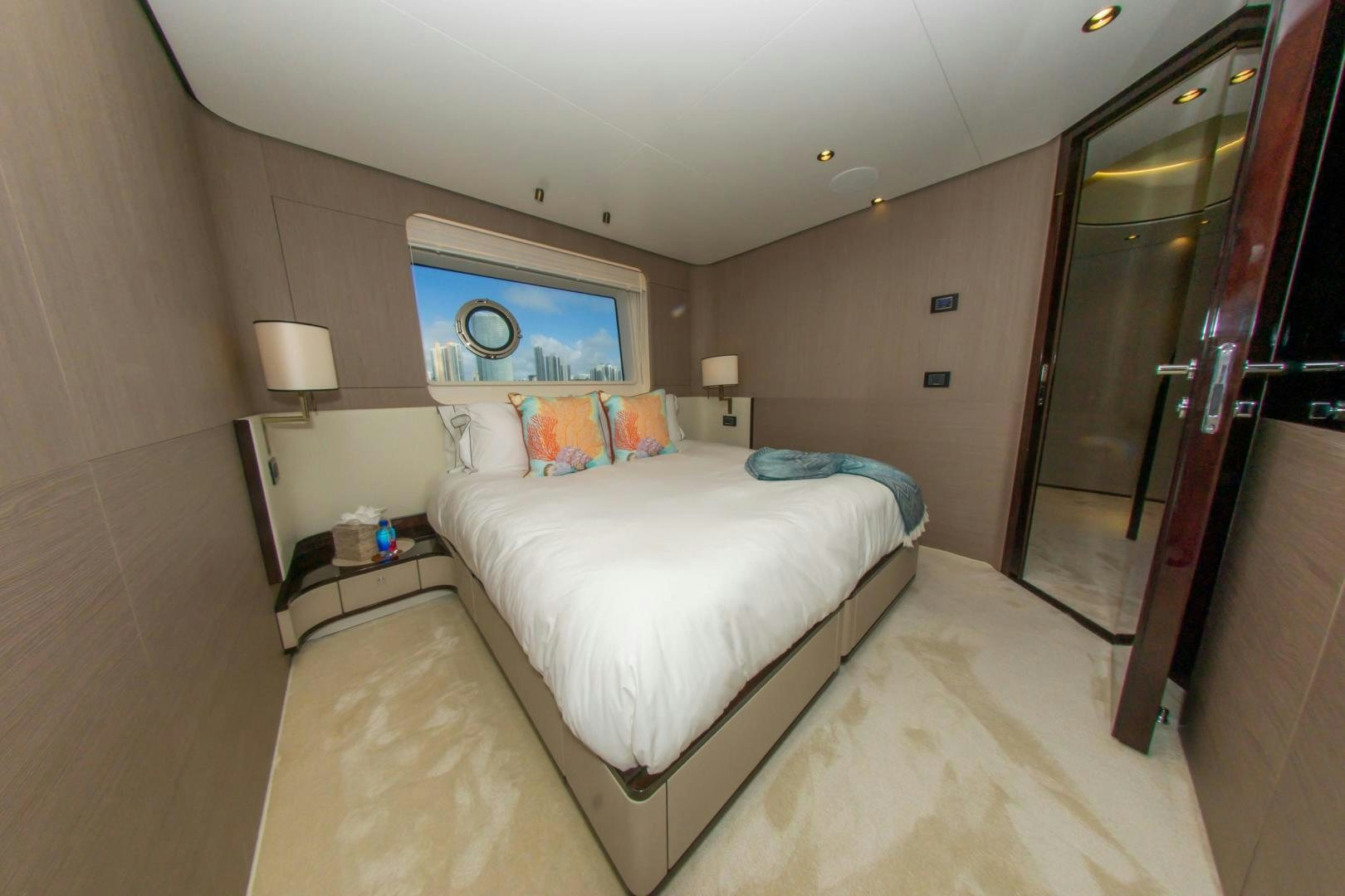 a bedroom with a bed and a television aboard RINA Yacht for Sale