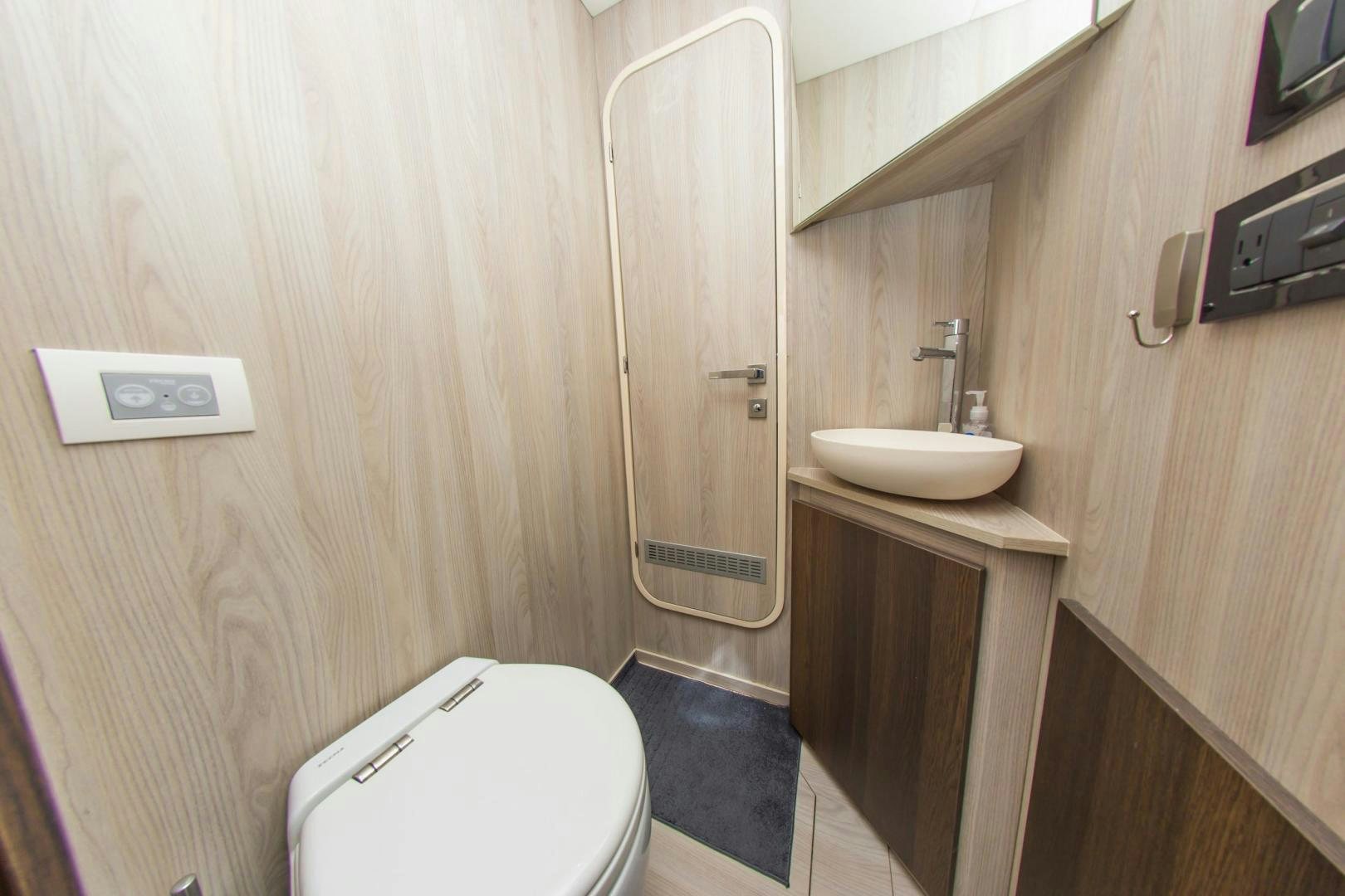 a bathroom with a toilet and sink aboard RINA Yacht for Sale