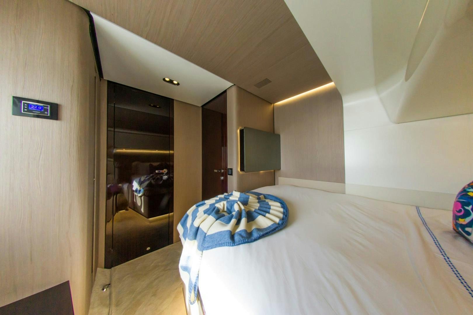 a bedroom with a bed and a blue blanket aboard RINA Yacht for Sale