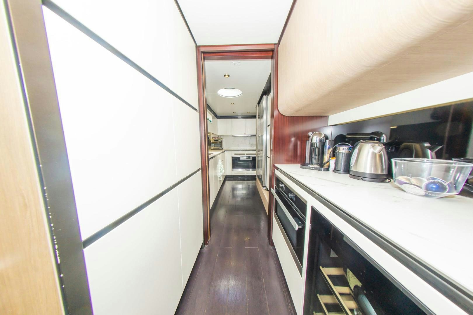 a kitchen with a white counter and stainless steel appliances aboard RINA Yacht for Sale