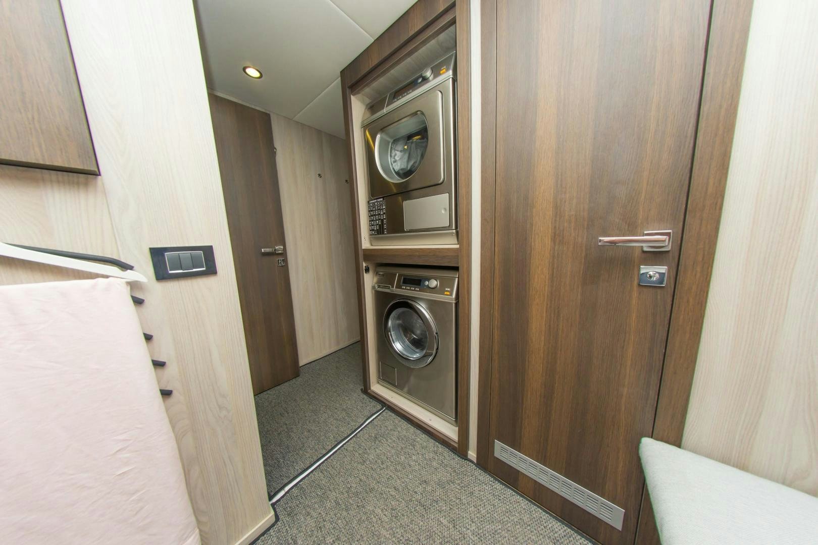 a small room with a washer and dryer aboard RINA Yacht for Sale