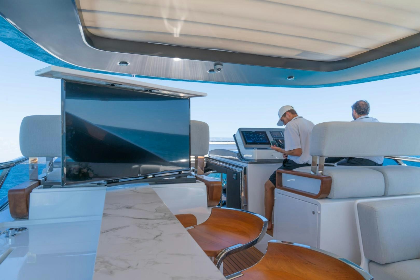 a couple of men sitting in a room with computers aboard RINA Yacht for Sale