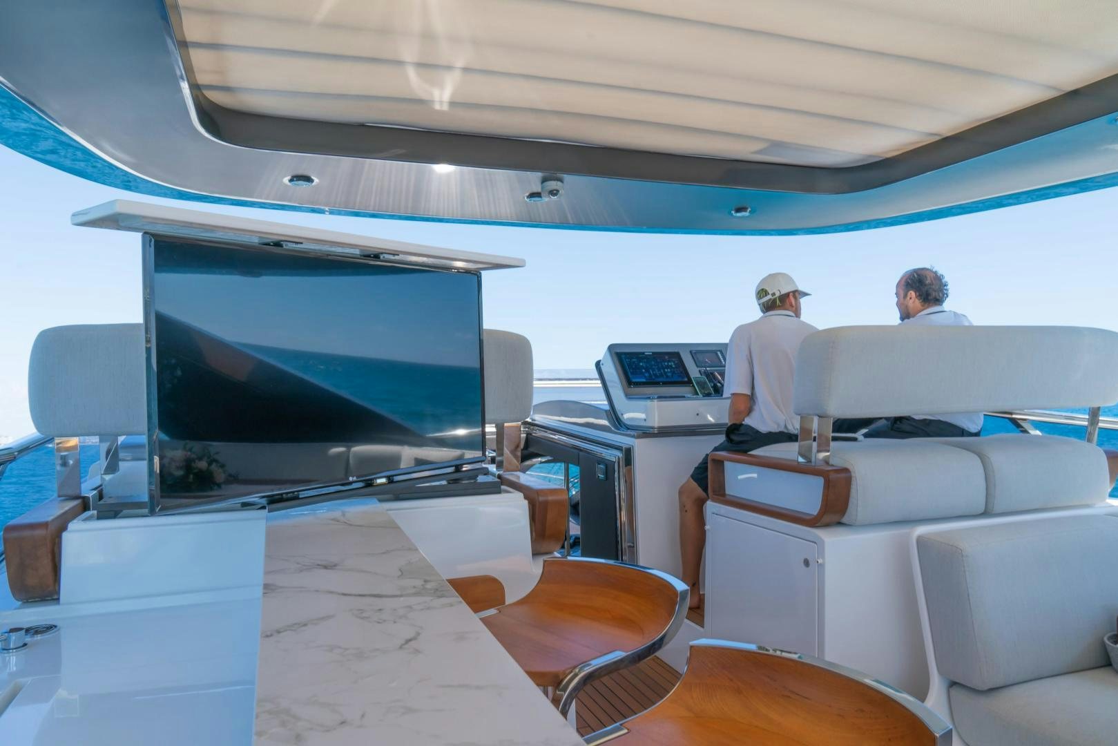 a couple of men sitting in a tent aboard RINA Yacht for Sale