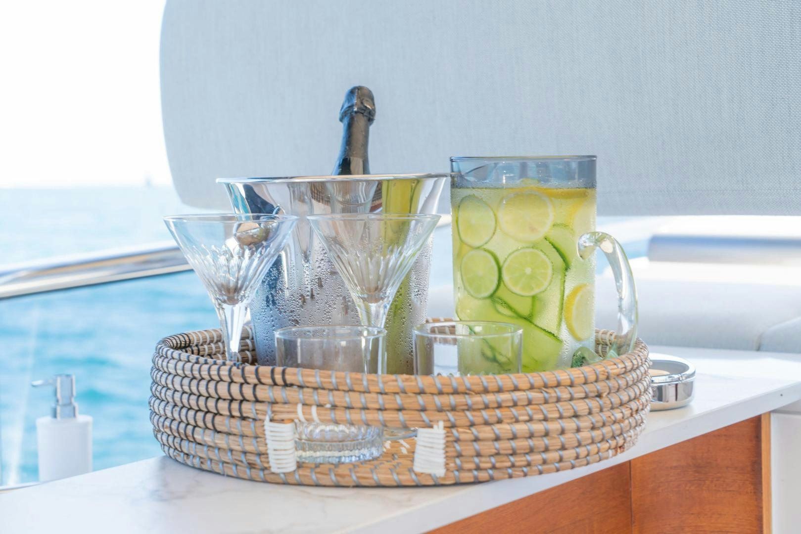 a basket of fruit and a glass of juice on a table aboard RINA Yacht for Sale