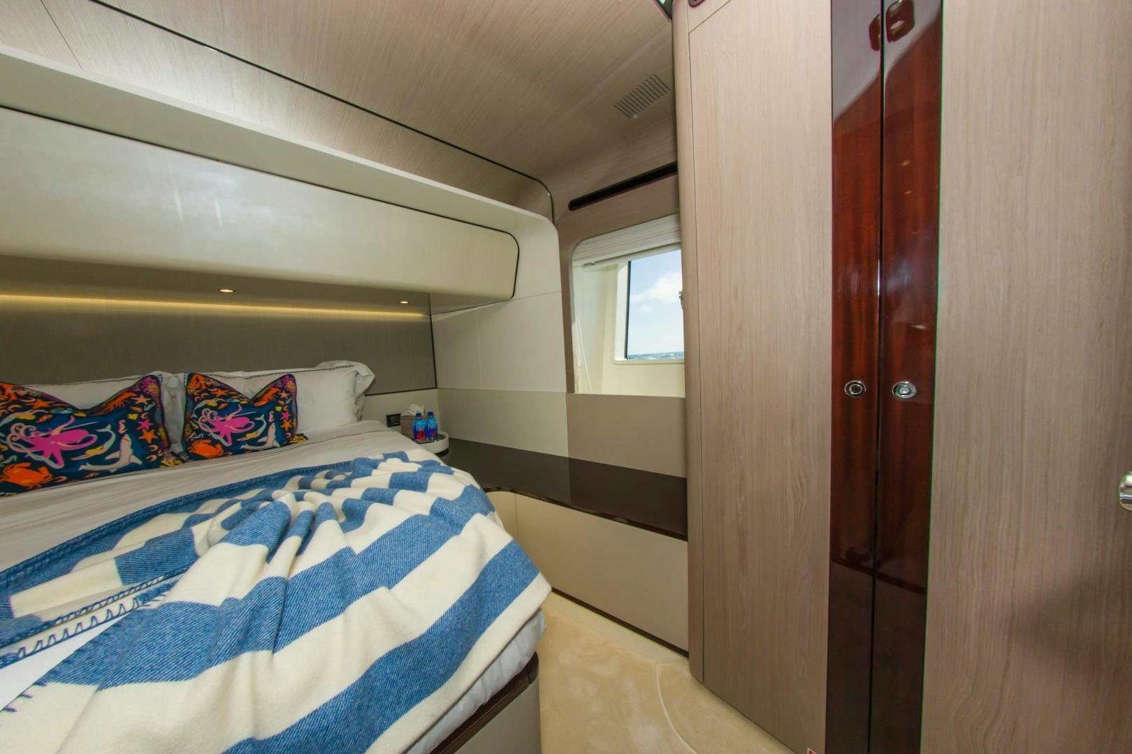 a room with a bed and a door aboard RINA Yacht for Sale