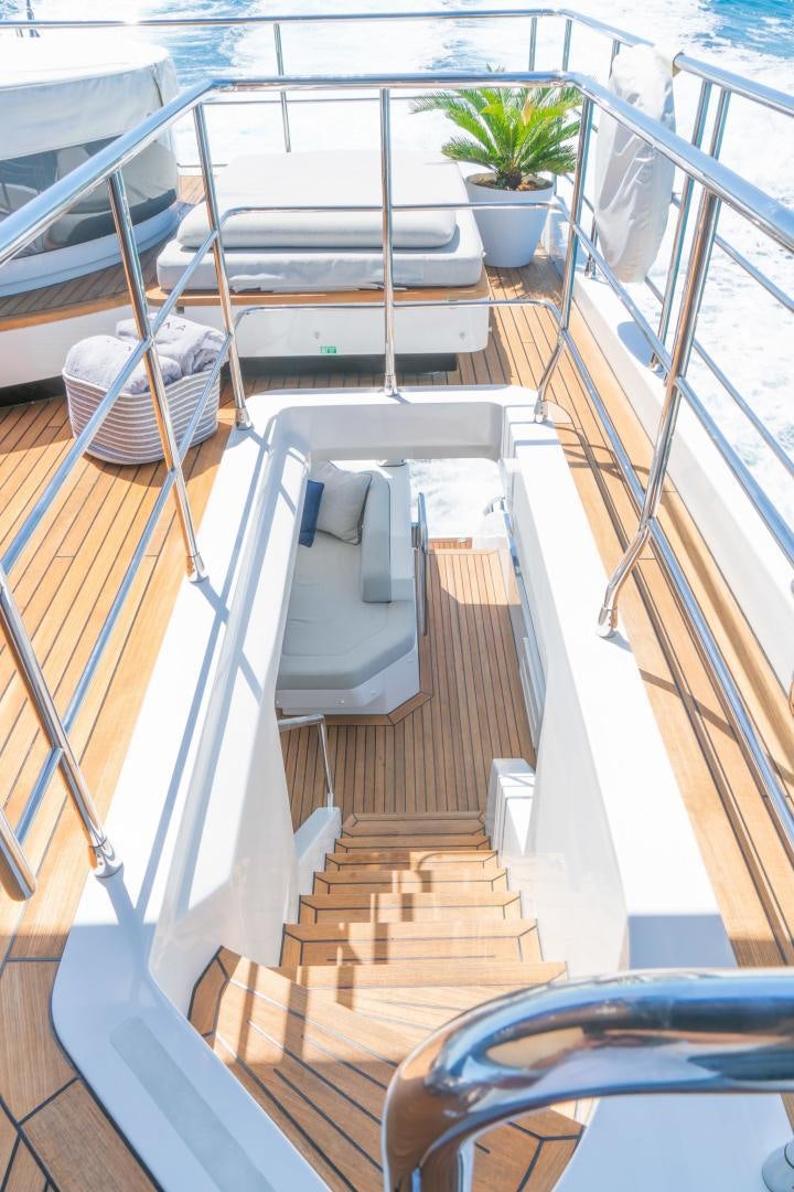 a balcony with a table and chairs aboard RINA Yacht for Sale