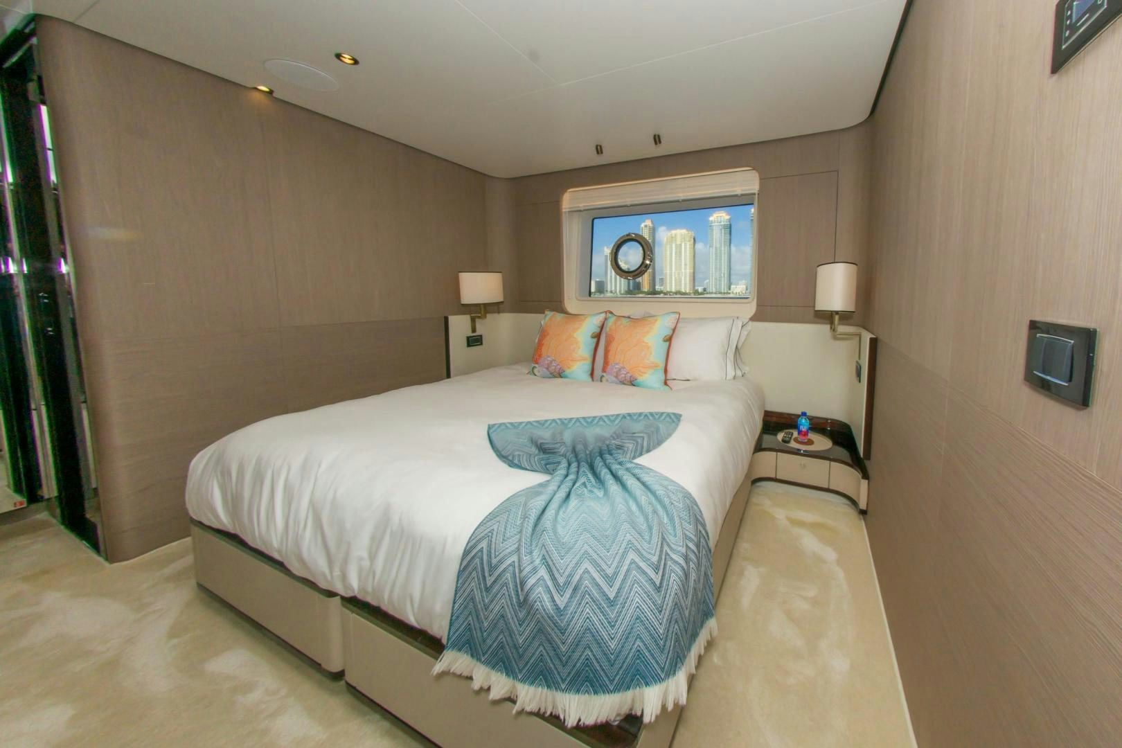 a bedroom with a bed and a lamp aboard RINA Yacht for Sale