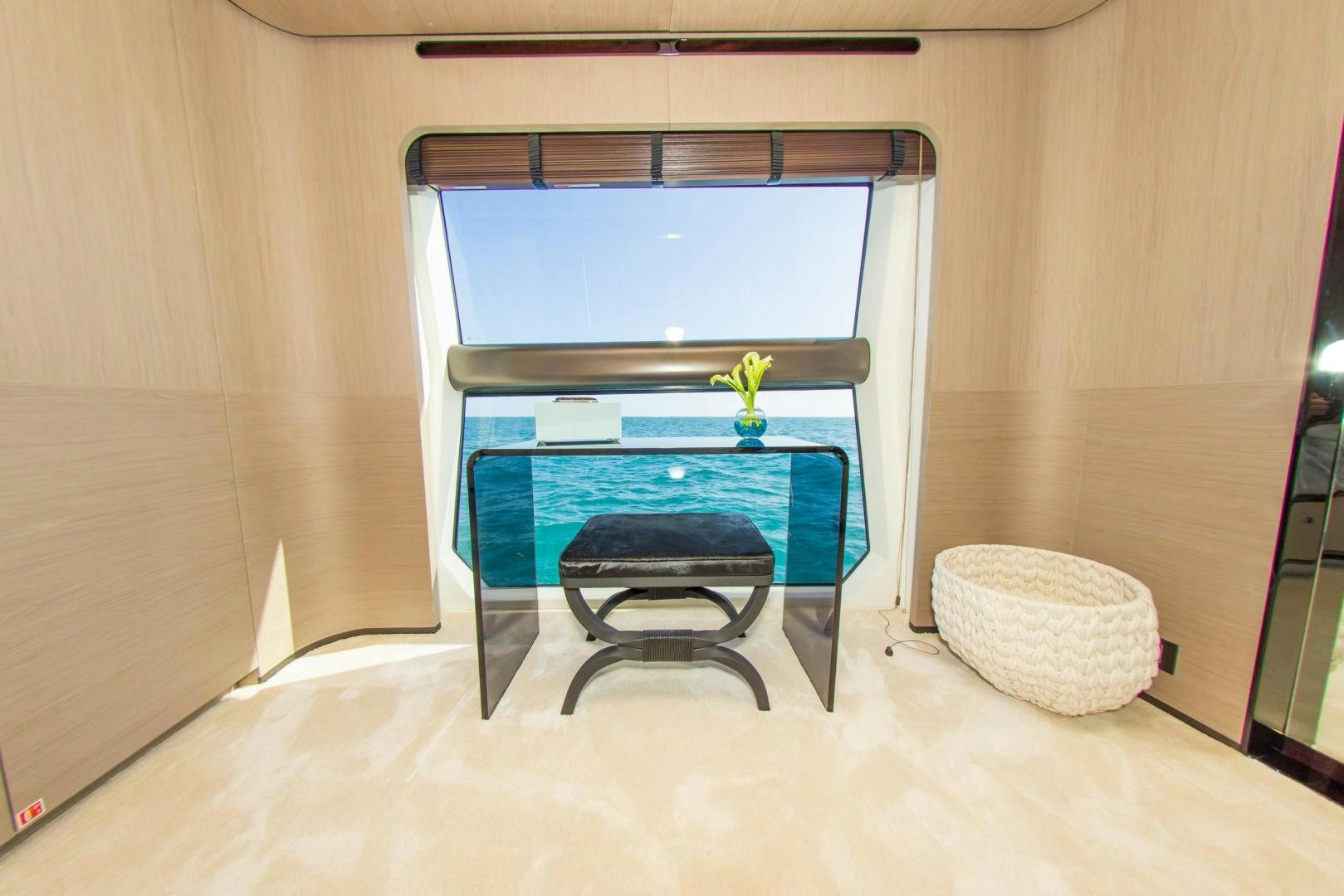 a table and a chair in a room aboard RINA Yacht for Sale