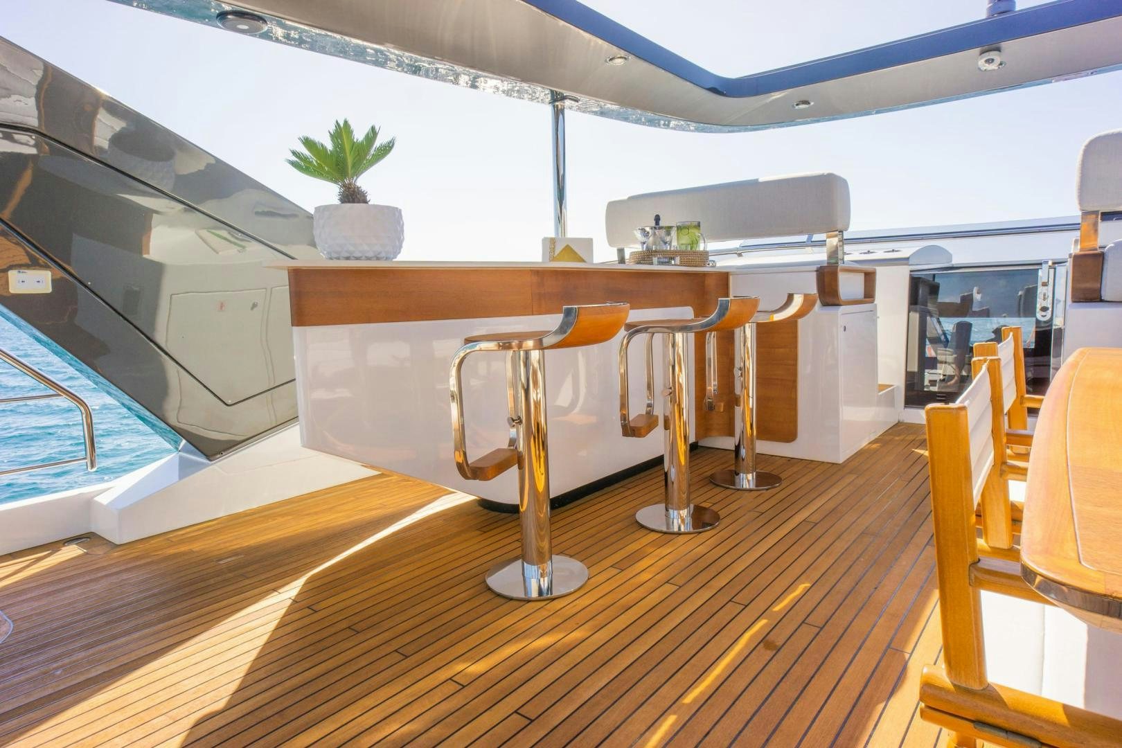 a room with tables and chairs aboard RINA Yacht for Sale