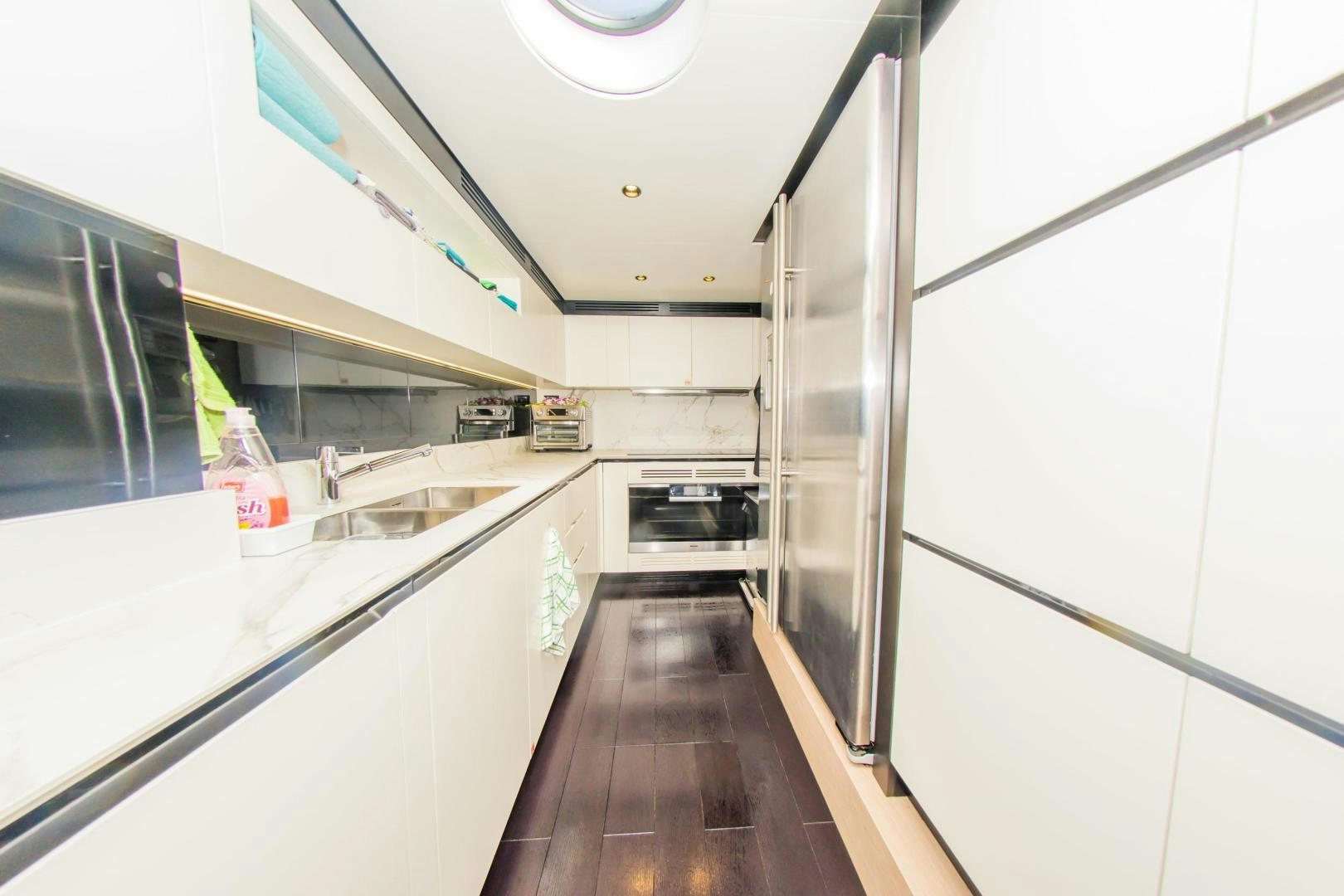 a kitchen with a stainless steel refrigerator aboard RINA Yacht for Sale