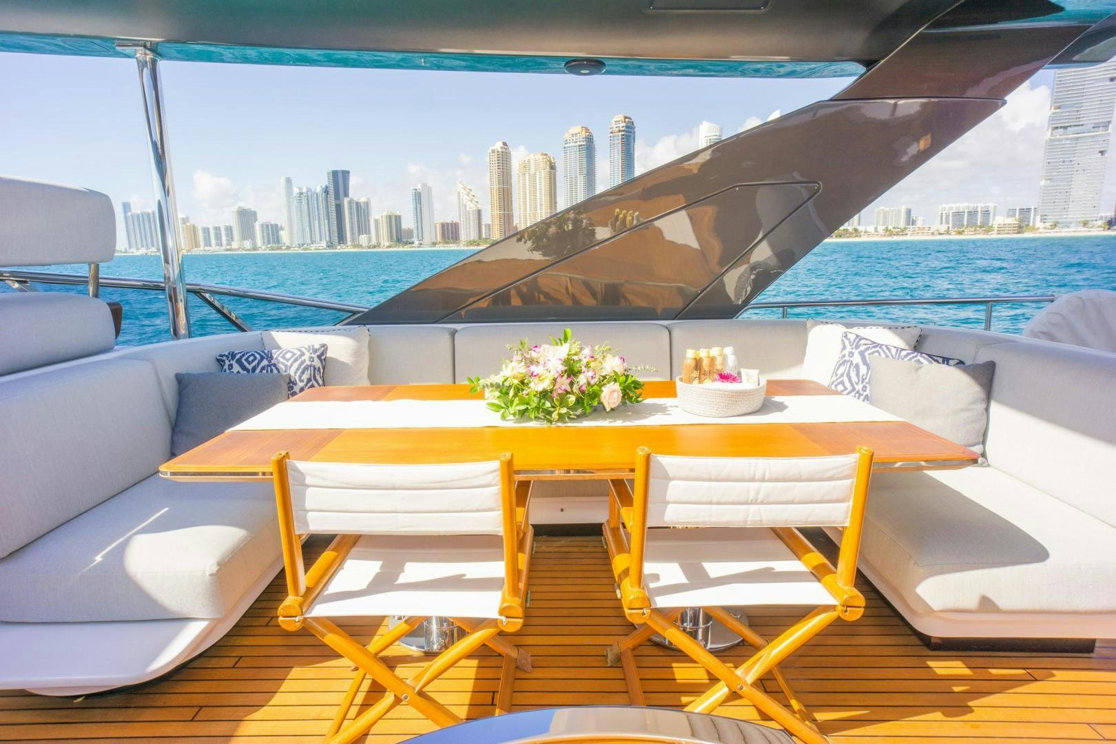 a table with chairs and a view of a city aboard RINA Yacht for Sale