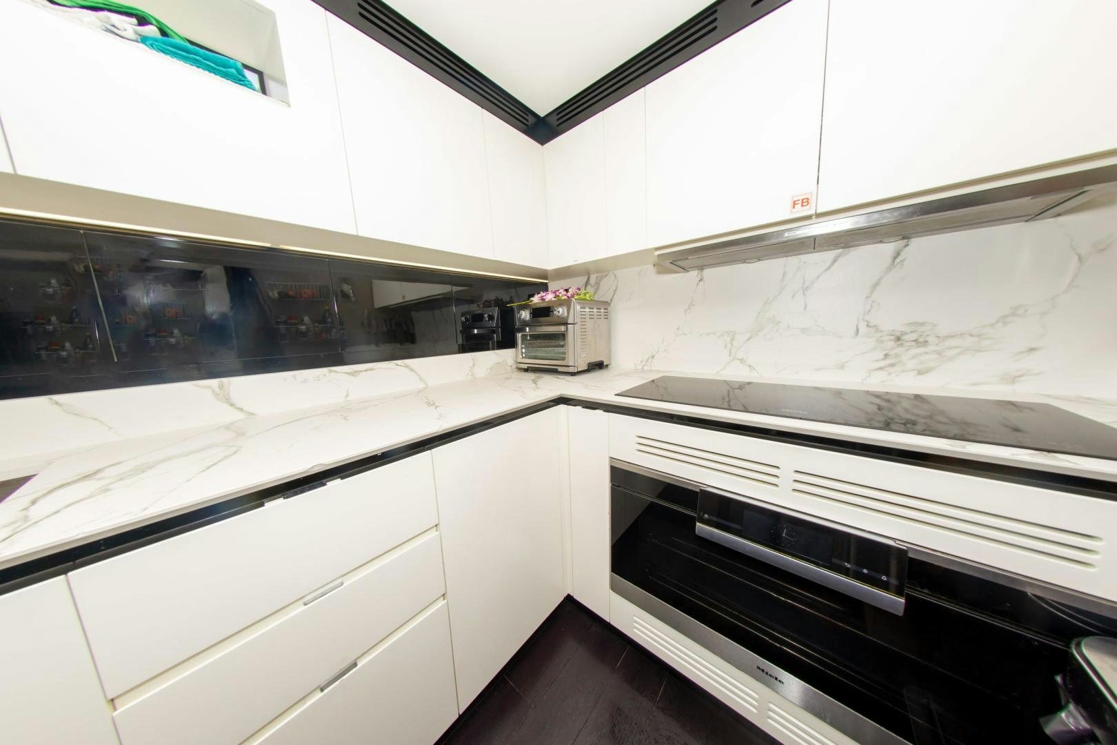 a kitchen with white cabinets aboard RINA Yacht for Sale