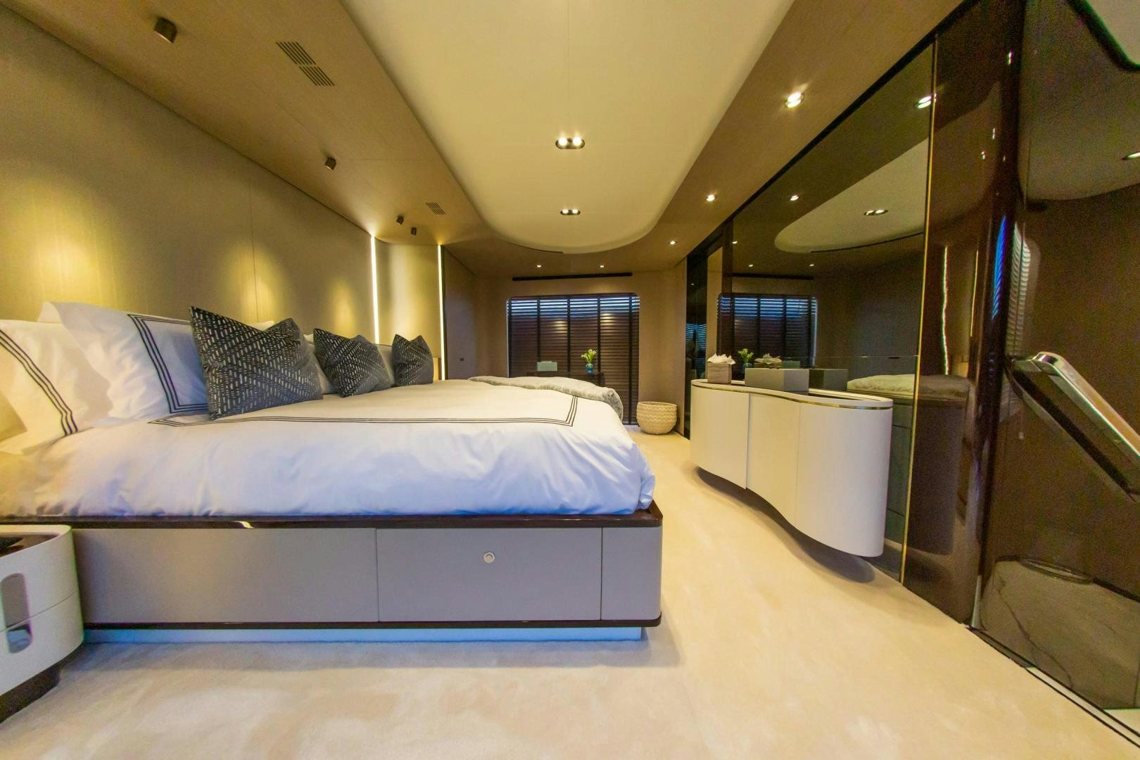 a room with a bed and a mirror aboard RINA Yacht for Sale