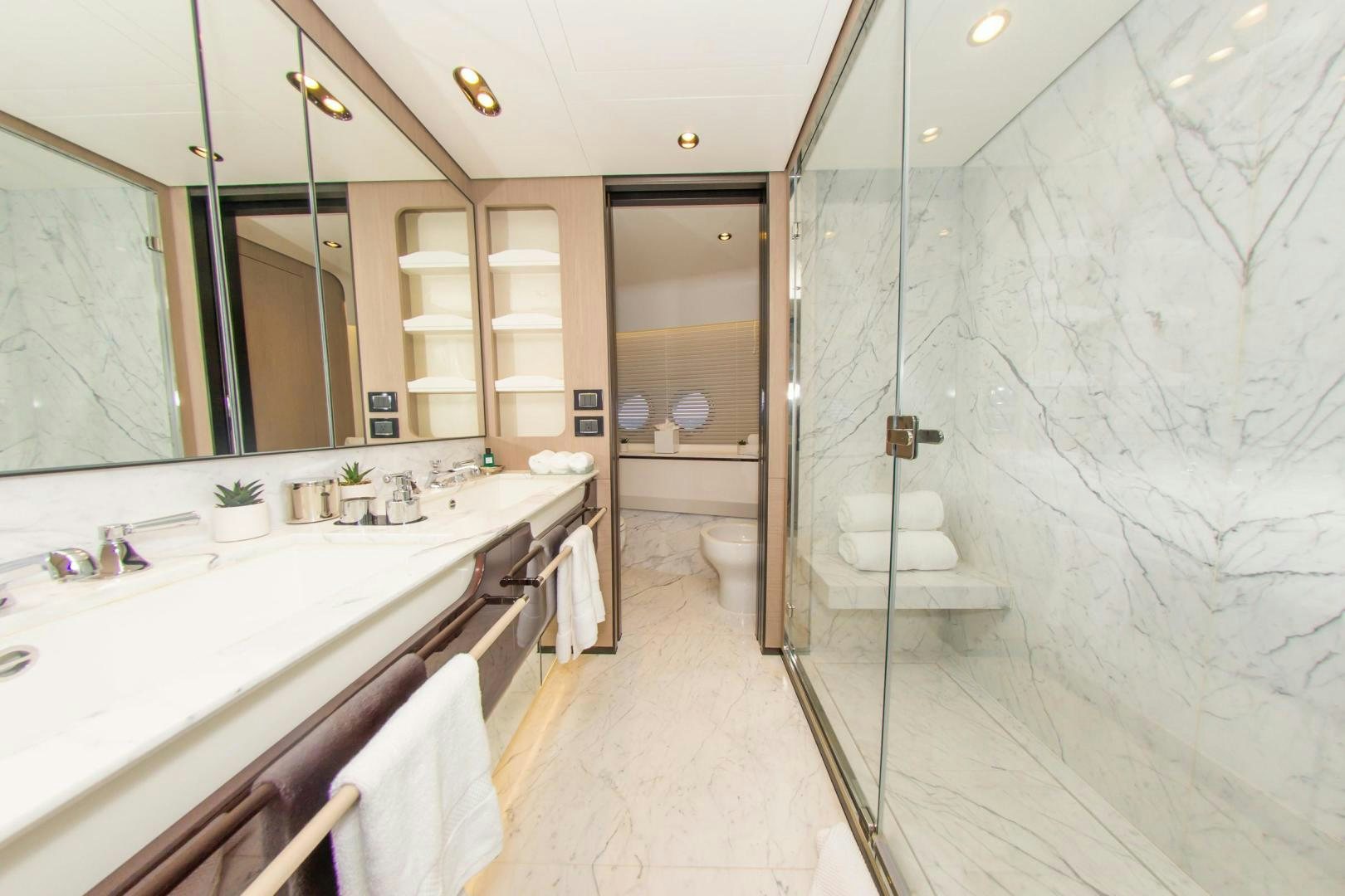a bathroom with a glass shower aboard RINA Yacht for Sale