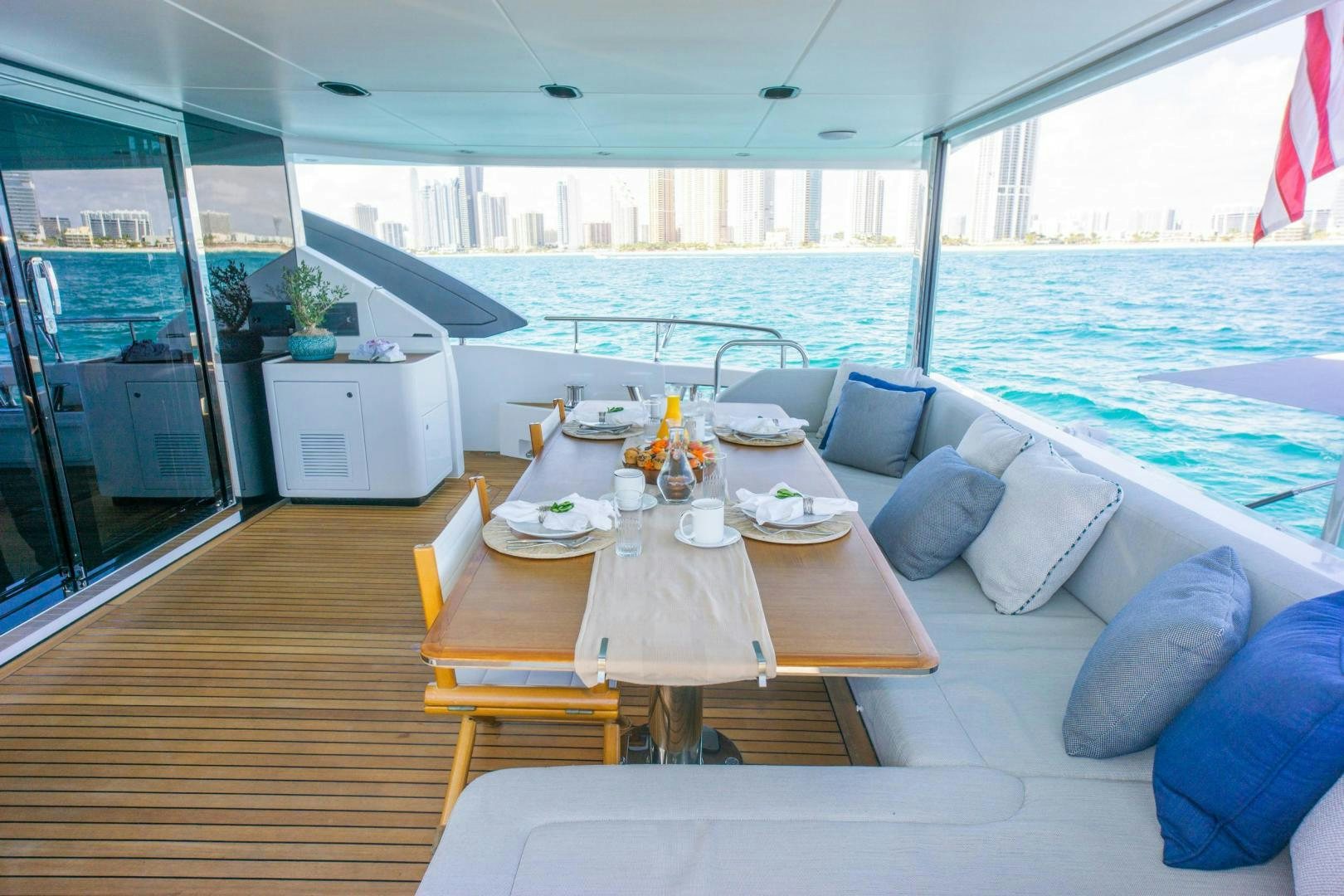 a table with chairs on it next to a large body of water aboard RINA Yacht for Sale