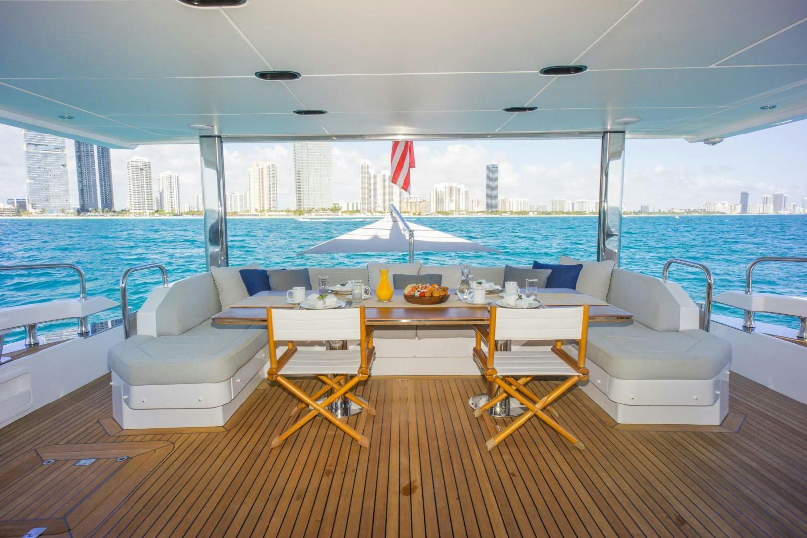 a room with a table chairs and a view of the water aboard RINA Yacht for Sale