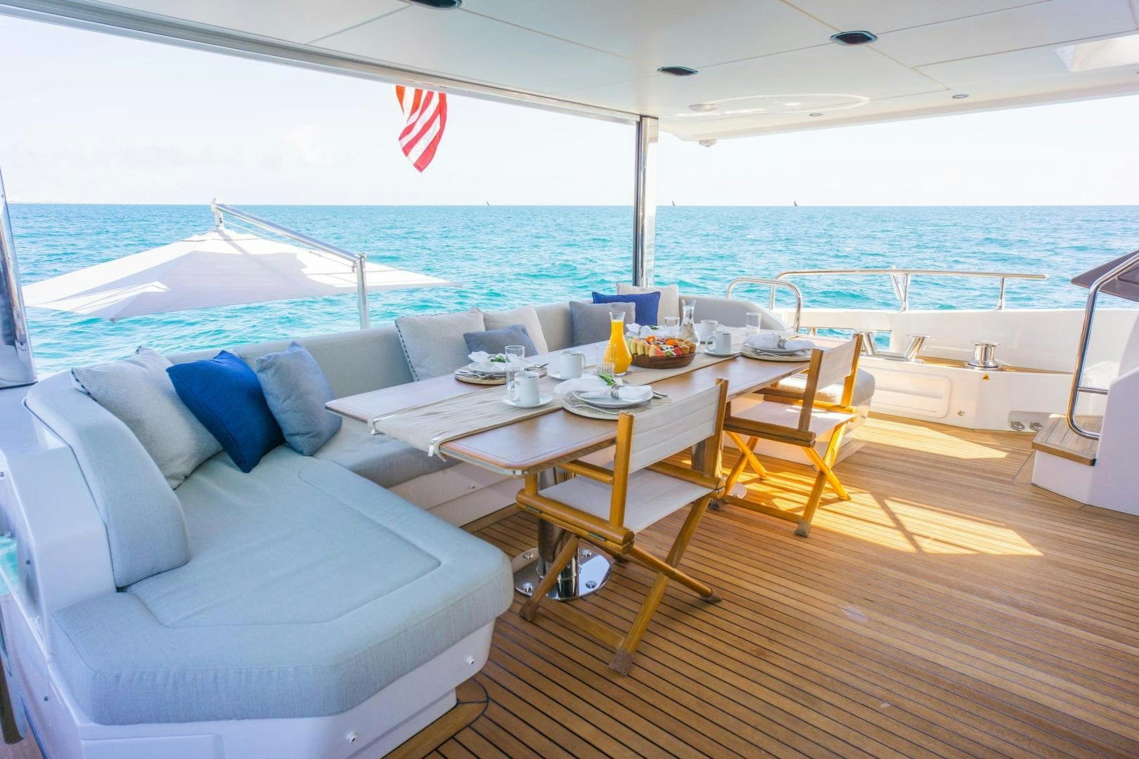 a large living room with a large balcony overlooking the ocean aboard RINA Yacht for Sale