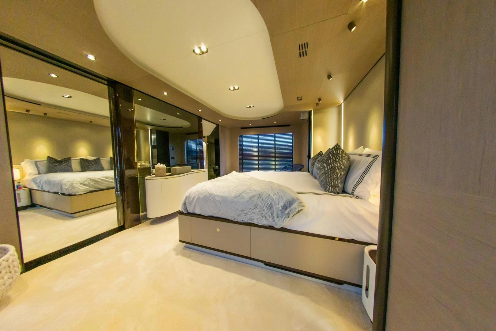 a room with a bed and a mirror aboard RINA Yacht for Sale