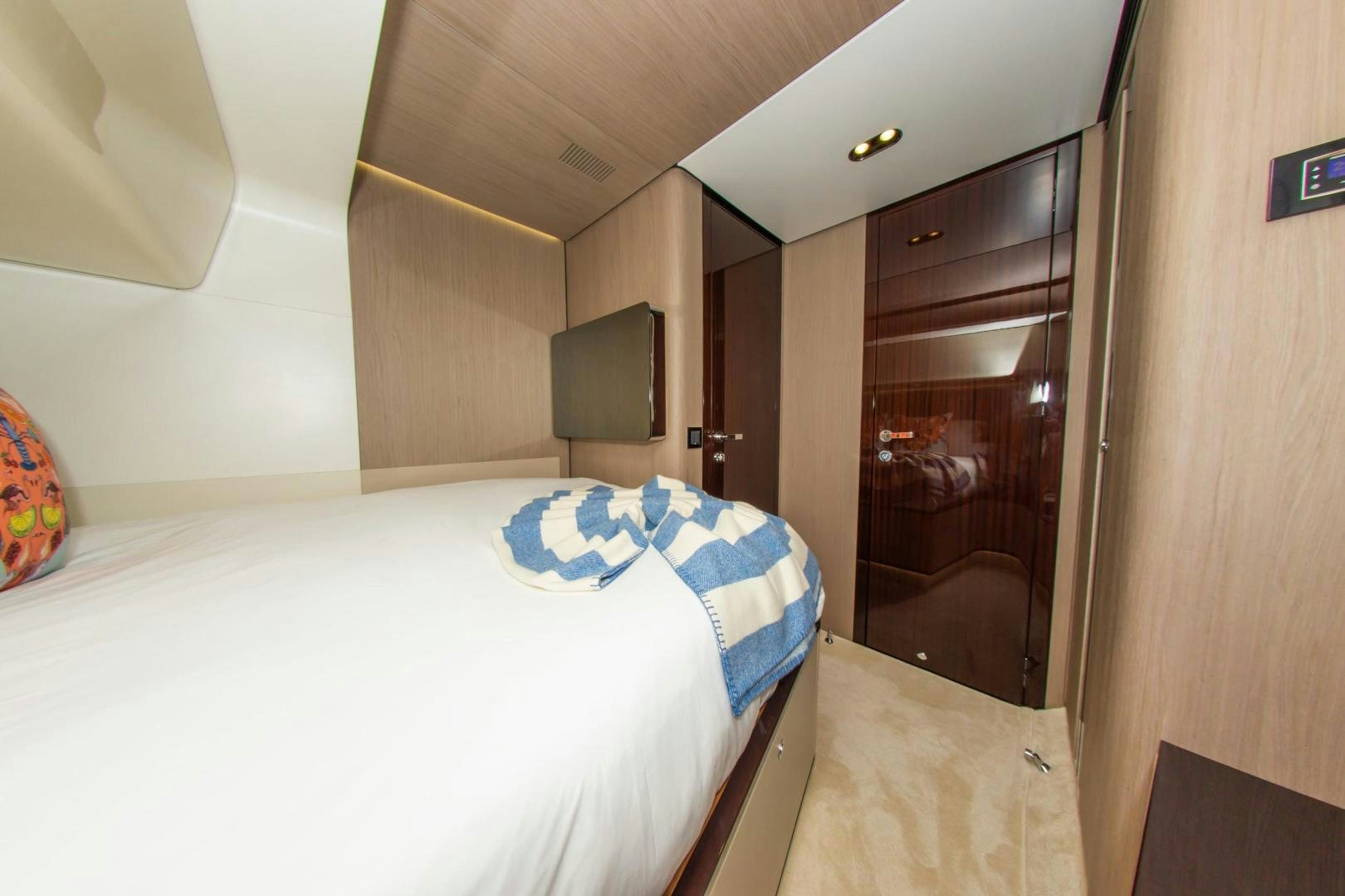 a bedroom with a bed and a closet aboard RINA Yacht for Sale