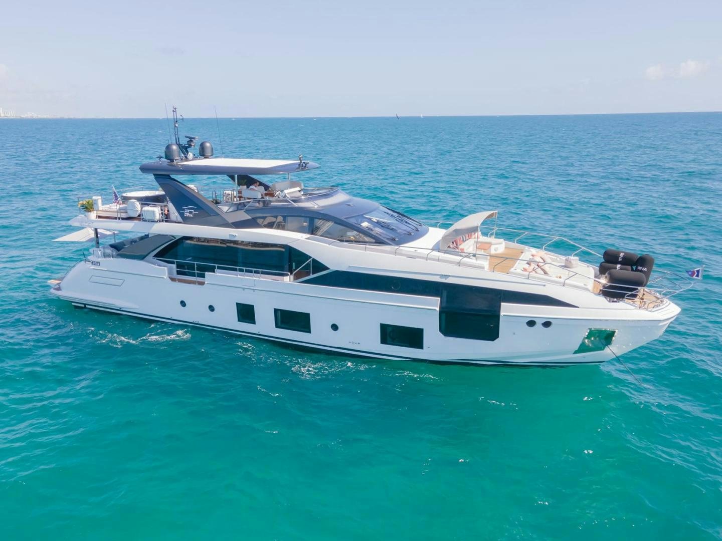 a white yacht in the ocean aboard RINA Yacht for Sale