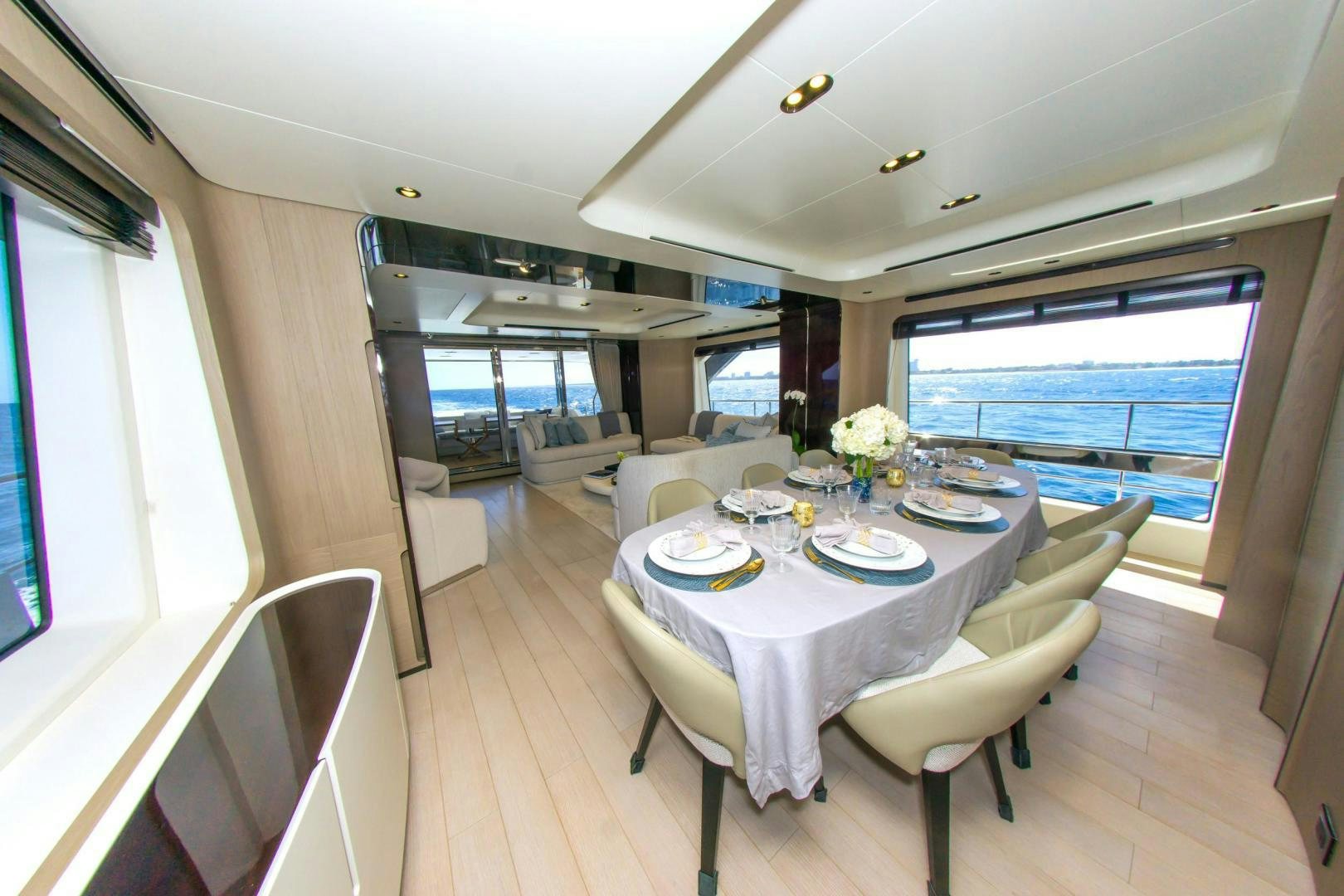 a dining room with a large window aboard RINA Yacht for Sale