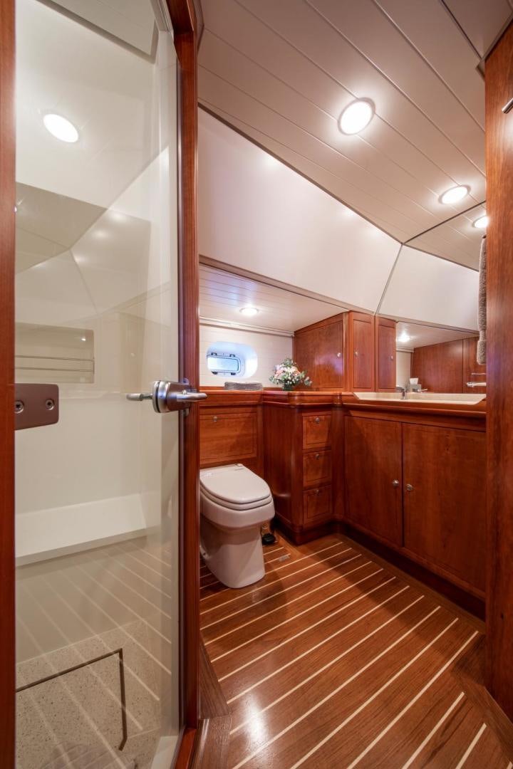 a bathroom with wooden cabinets aboard WAVELENGTH Yacht for Sale