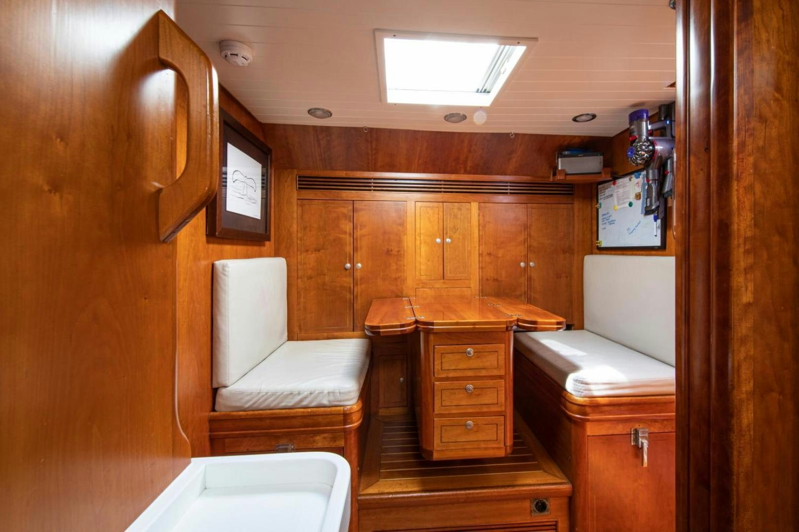 a room with a bed and a chair aboard WAVELENGTH Yacht for Sale