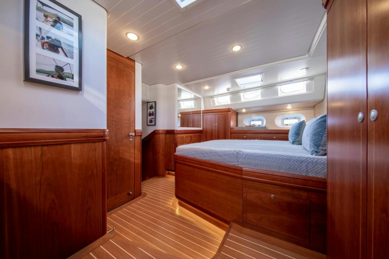 a bedroom with wood furniture aboard WAVELENGTH Yacht for Sale