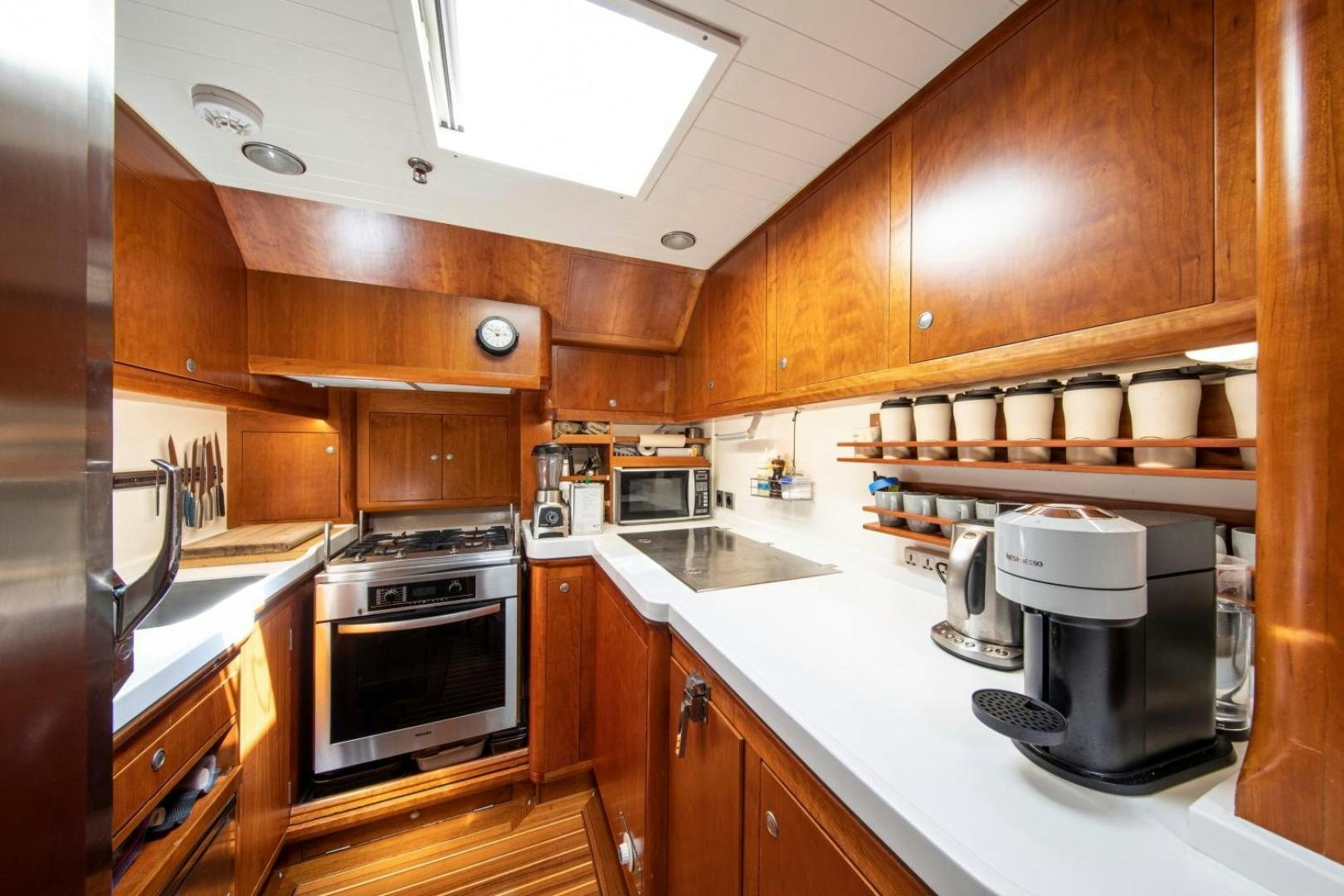 a kitchen with wooden cabinets aboard WAVELENGTH Yacht for Sale
