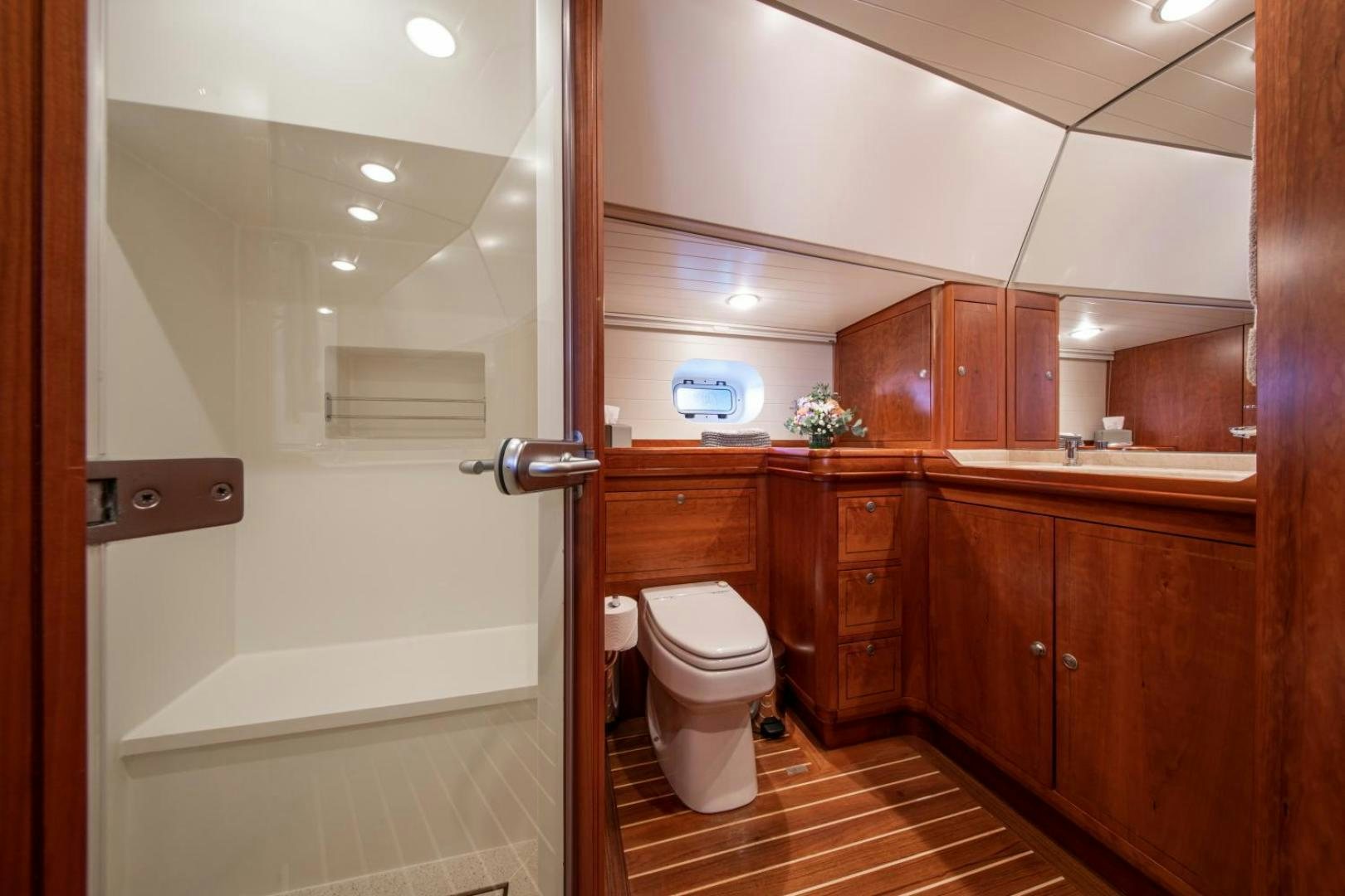 a bathroom with wooden cabinets aboard WAVELENGTH Yacht for Sale