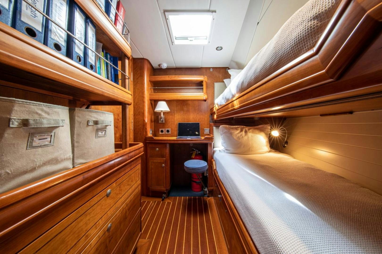a bedroom with a wood floor aboard WAVELENGTH Yacht for Sale