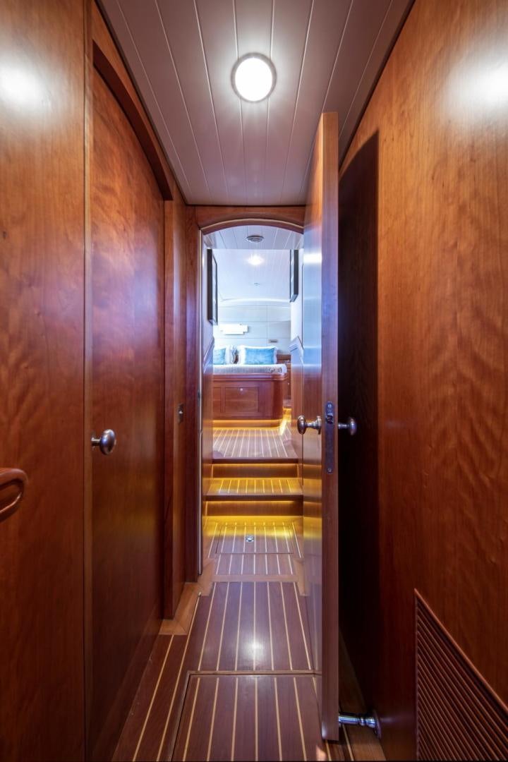 a hallway with wooden doors aboard WAVELENGTH Yacht for Sale