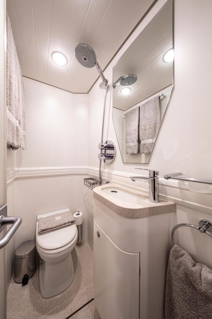a bathroom with a toilet and a sink aboard WAVELENGTH Yacht for Sale