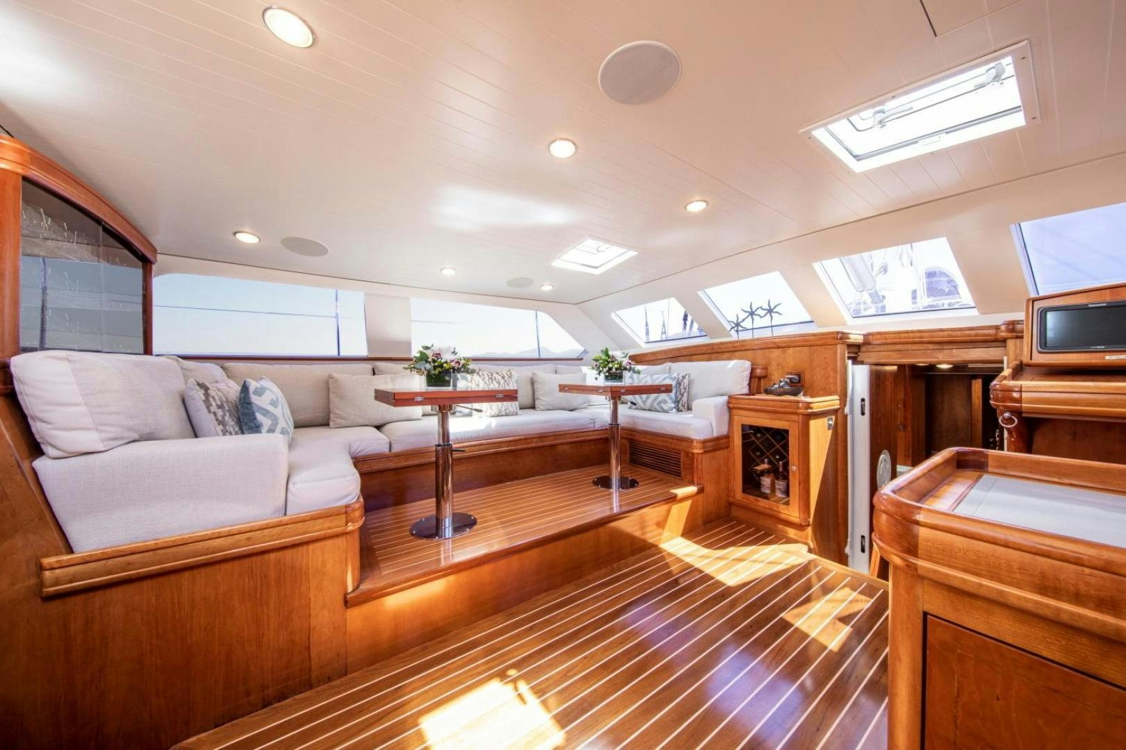 a living room with a couch and a table aboard WAVELENGTH Yacht for Sale