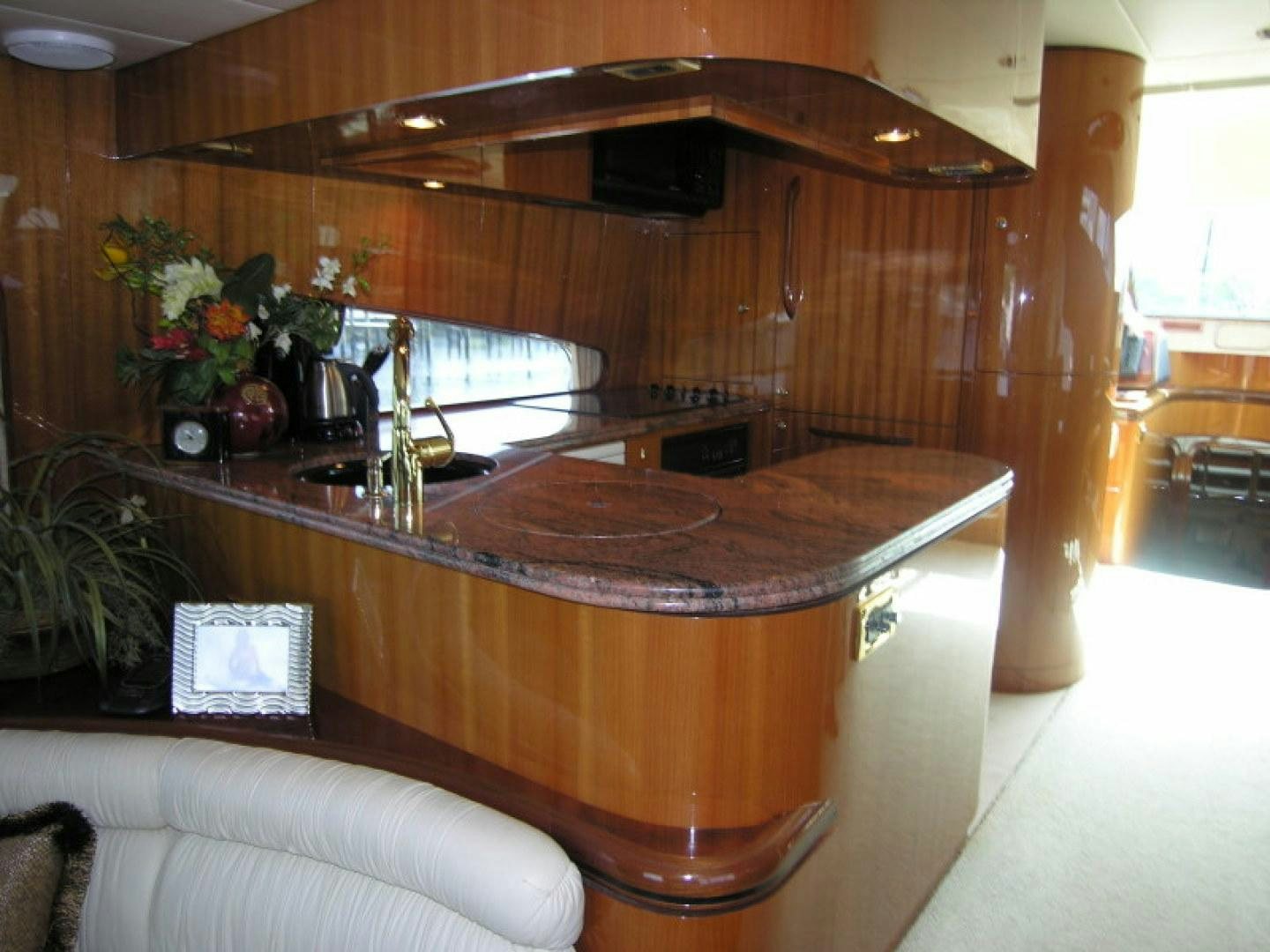 a large wooden table with a bench aboard BALOZI Yacht for Sale