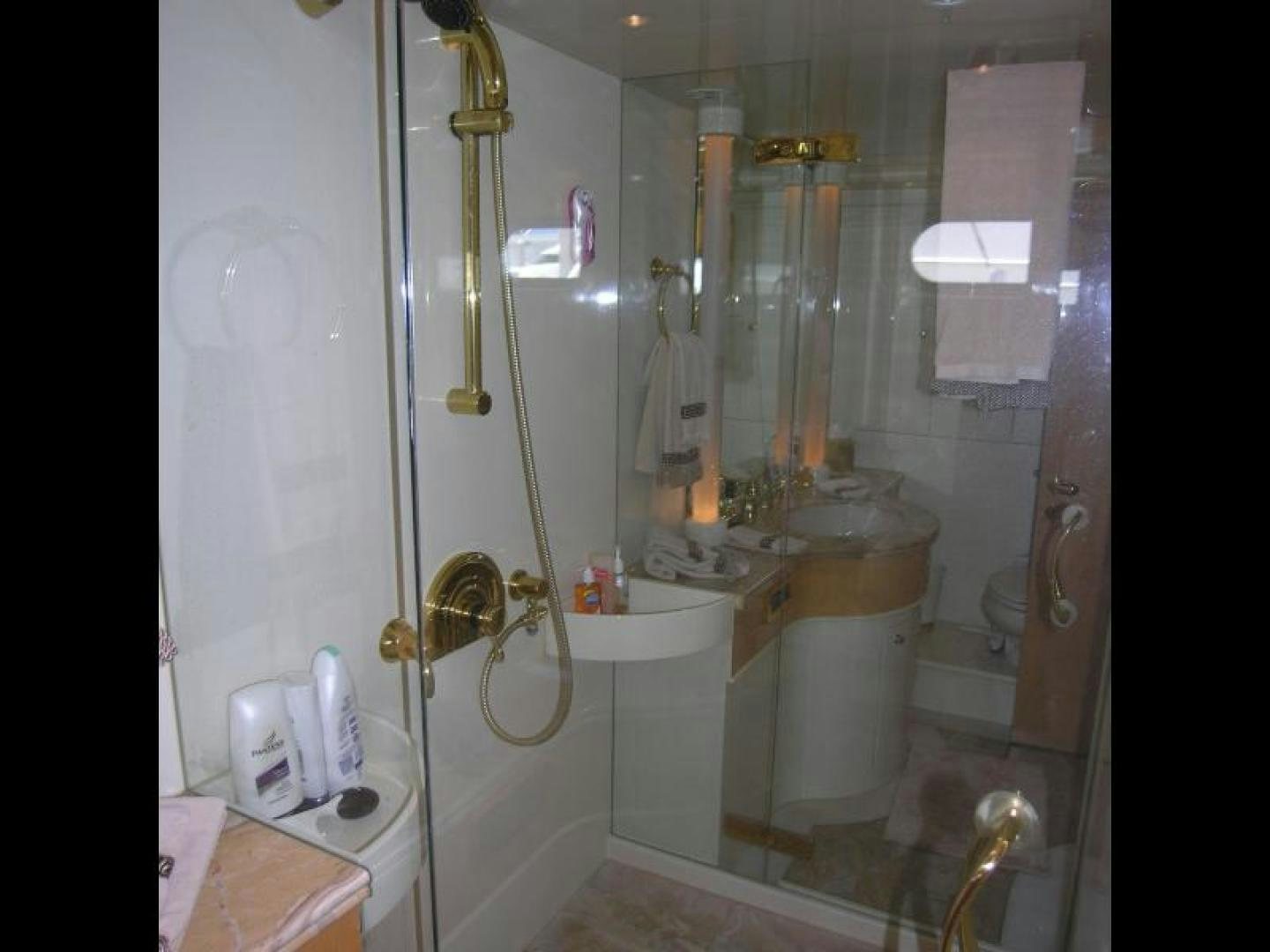 a bathroom with a glass shower aboard BALOZI Yacht for Sale
