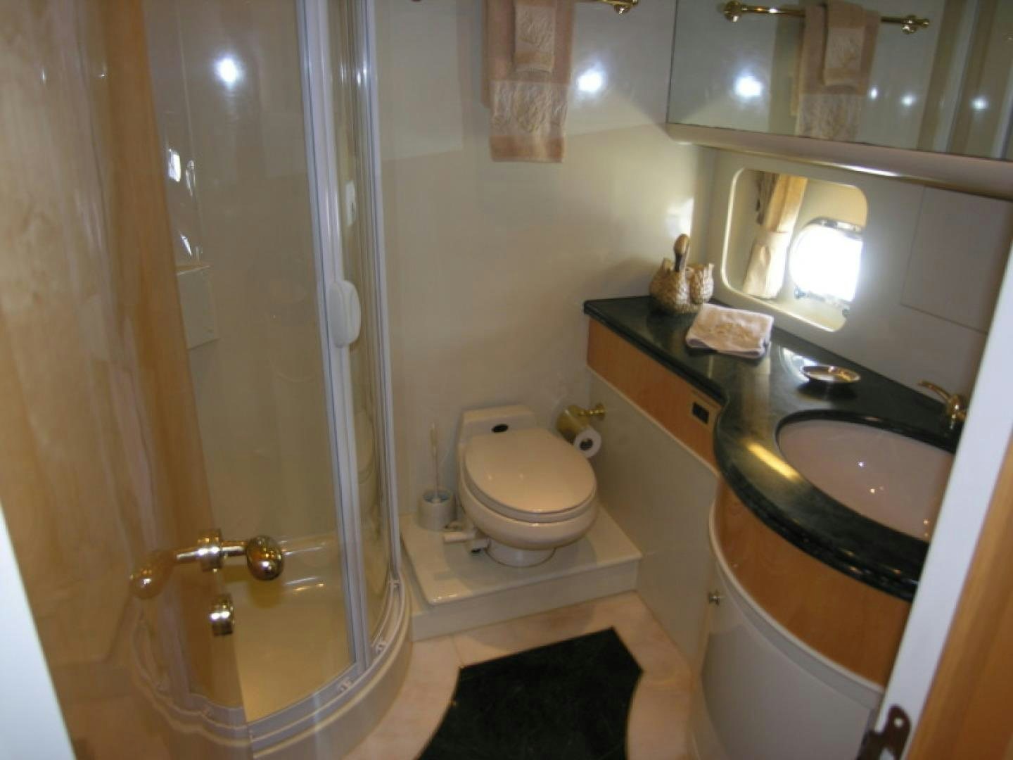 a bathroom with a glass shower aboard BALOZI Yacht for Sale