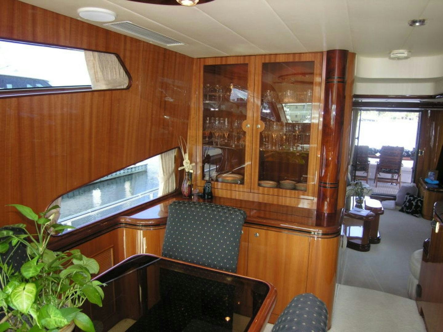 a room with a table chairs and a large glass window aboard BALOZI Yacht for Sale