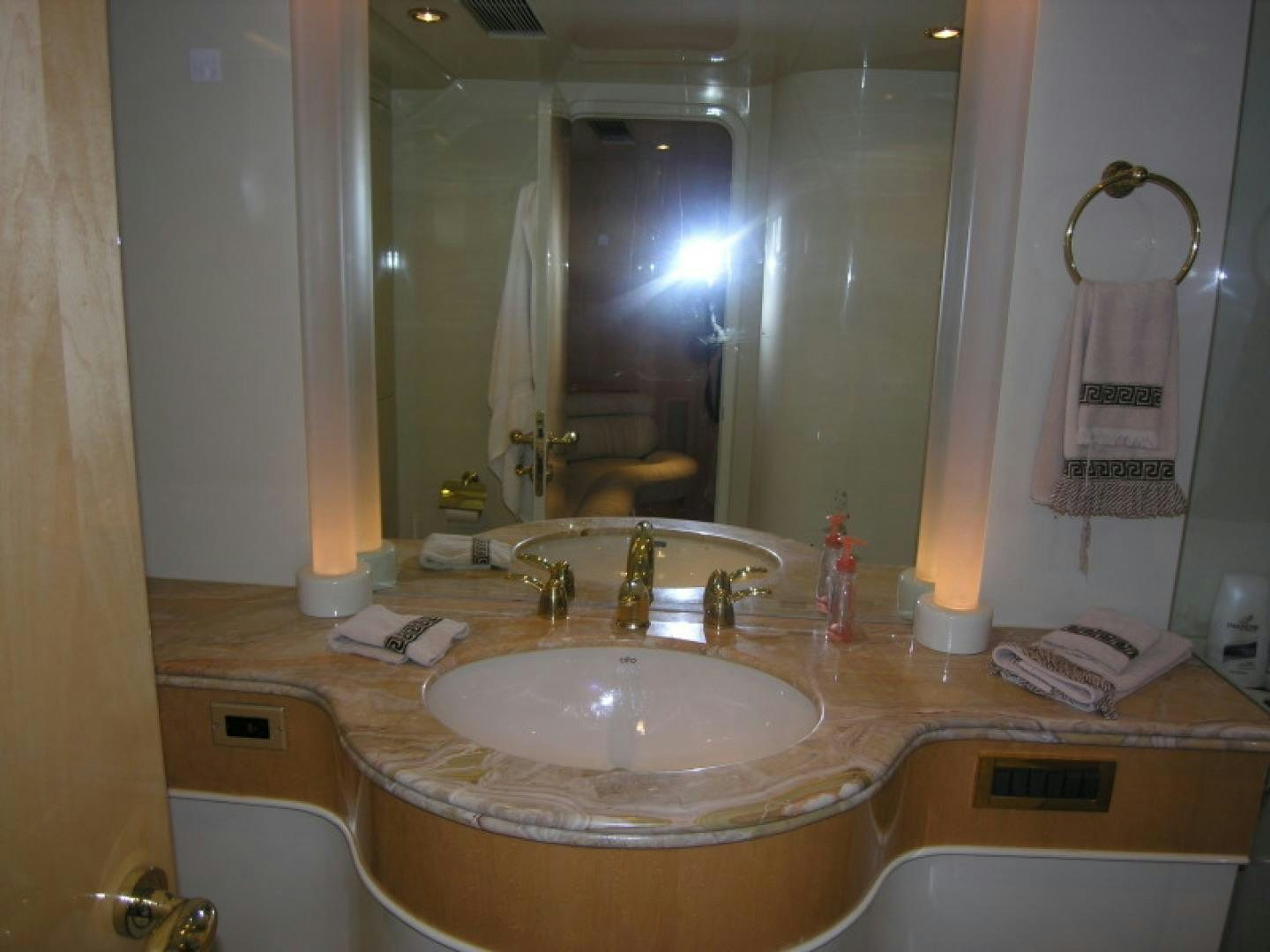 a bathroom with a large mirror aboard BALOZI Yacht for Sale