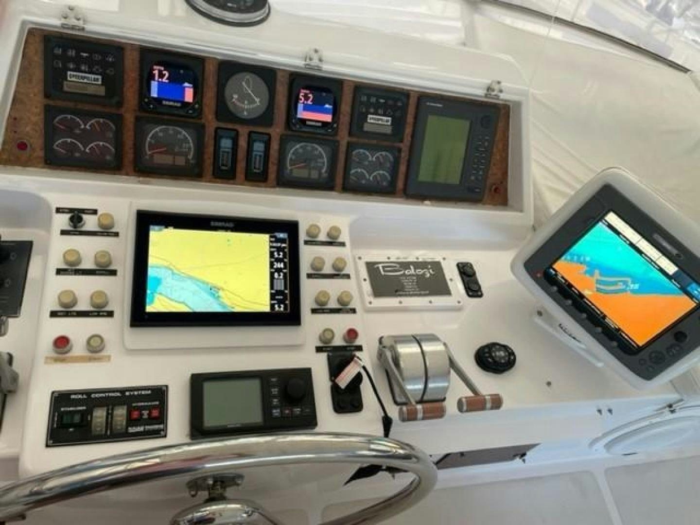 a computer desk with a monitor and other electronic devices aboard BALOZI Yacht for Sale