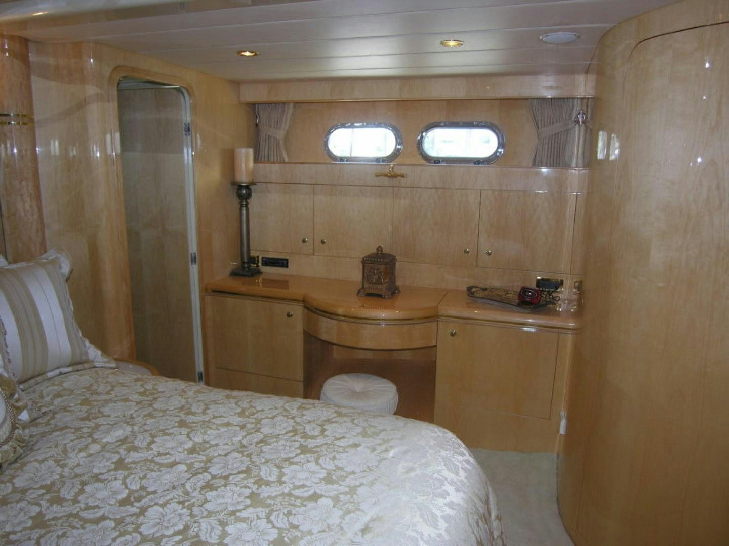 a bedroom with a bed and desk aboard BALOZI Yacht for Sale