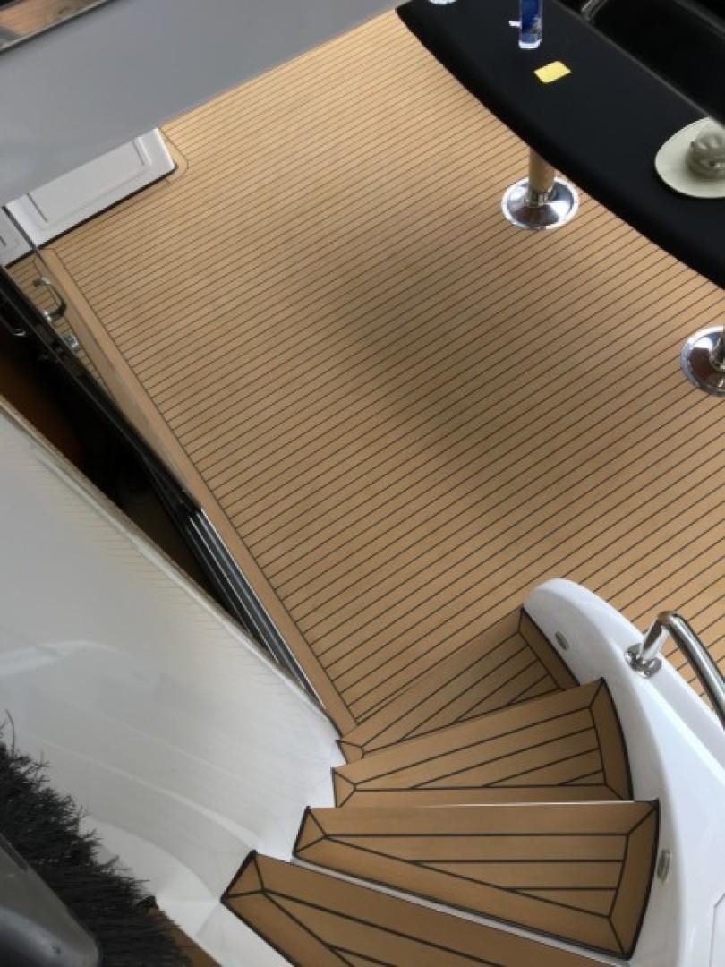 a wooden staircase with a white railing aboard BALOZI Yacht for Sale